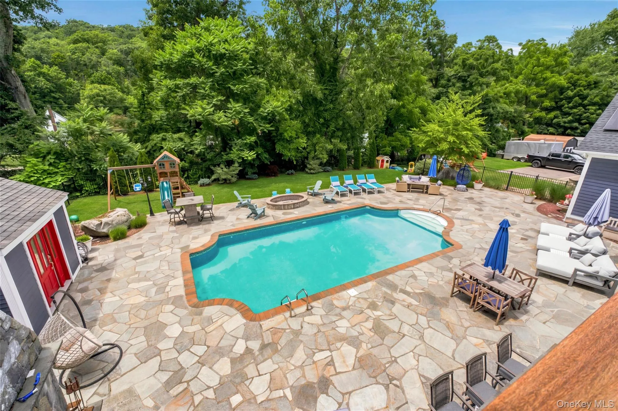 This beautifully designed outdoor space features a large pool, multiple seating areas, and a stone fireplace for year-round enjoyment. Updated saltwater pool system featuring a new saltwater pump and a new Pentair multi-stage, energy-efficient pool pump. This beautifully designed outdoor space features a large pool, multiple seating areas, and a stone fireplace for year-round enjoyment. Updated saltwater pool system featuring a new saltwater pump and a new Pentair multi-stage, energy-efficient pool pump.
