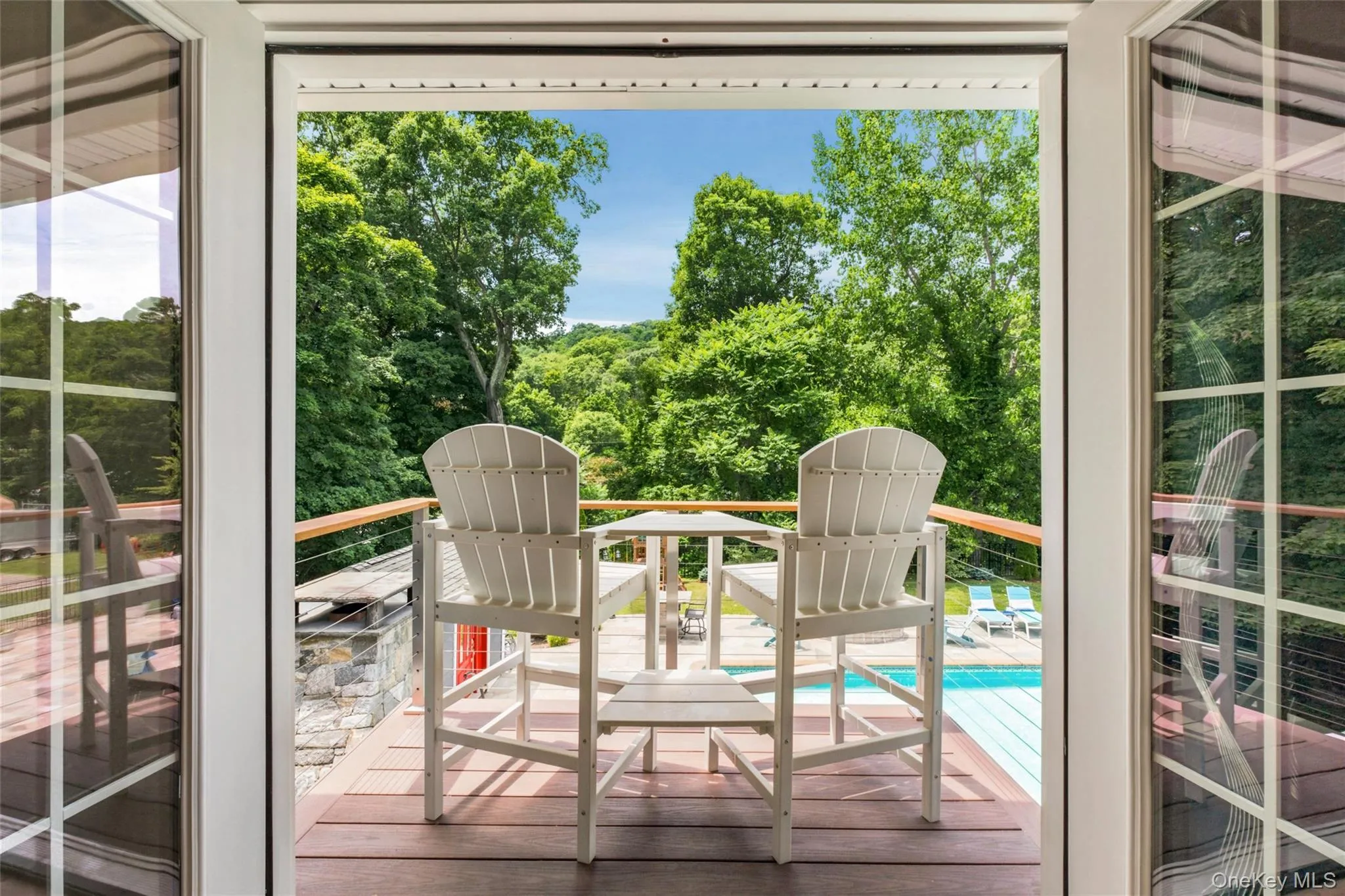 This charming balcony offers elevated views of the pool and lush backyard, creating a perfect spot to unwind. This charming balcony offers elevated views of the pool and lush backyard, creating a perfect spot to unwind.