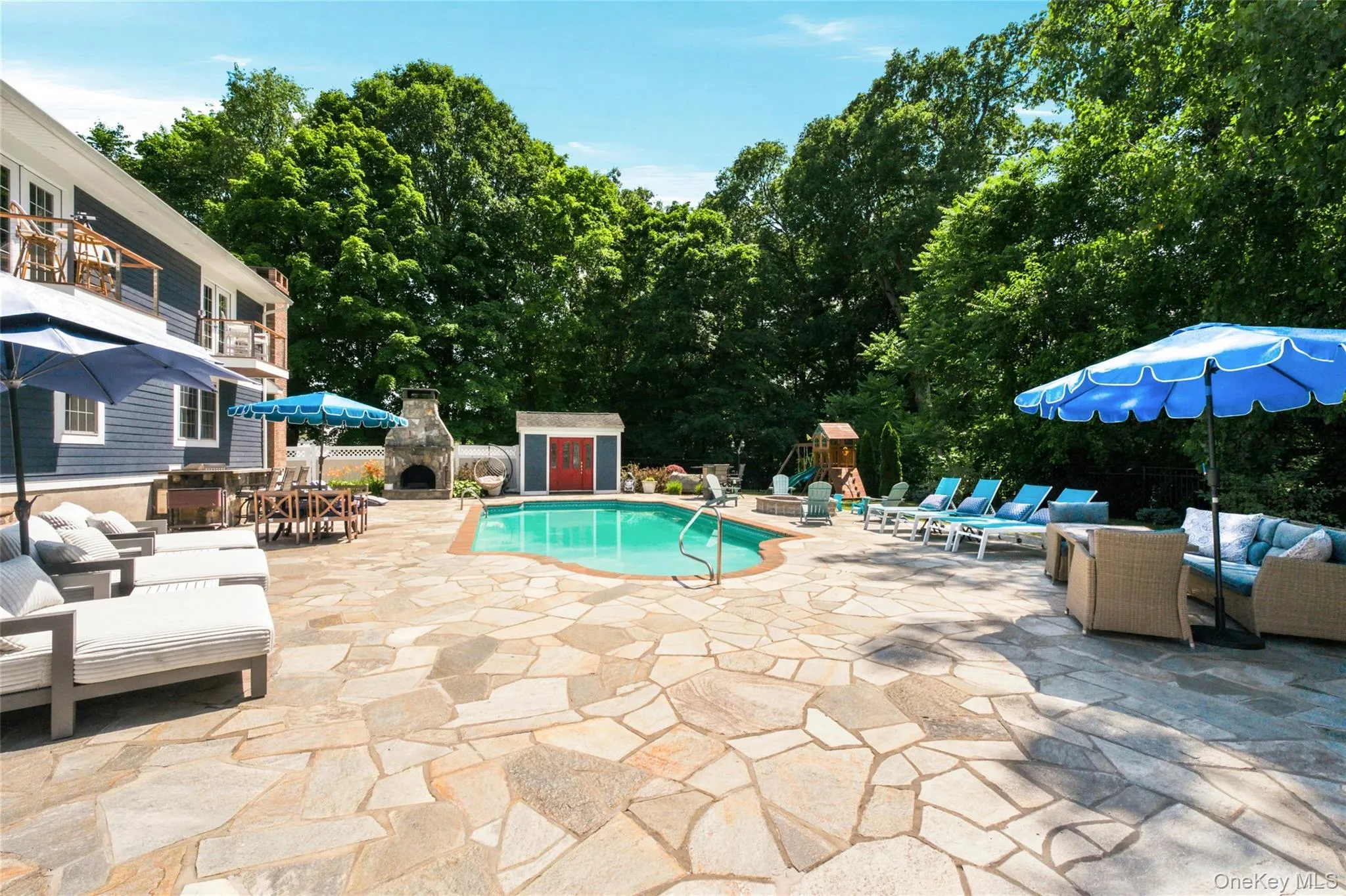 The backyard is an entertainer’s dream, offering a resort-style setting with a sparkling swimming pool, multiple lounge areas, and a stone patio. Enjoy evenings by the fire pit, meals at the outdoor bar, or relaxation by the outdoor fireplace. Surrounded by lush greenery and thoughtful landscaping, this outdoor space is designed for enjoyment and unforgettable gatherings. The backyard is an entertainer’s dream, offering a resort-style setting with a sparkling swimming pool, multiple lounge areas, and a stone patio. Enjoy evenings by the fire pit, meals at the outdoor bar, or relaxation by the outdoor fireplace. Surrounded by lush greenery and thoughtful landscaping, this outdoor space is designed for enjoyment and unforgettable gatherings.