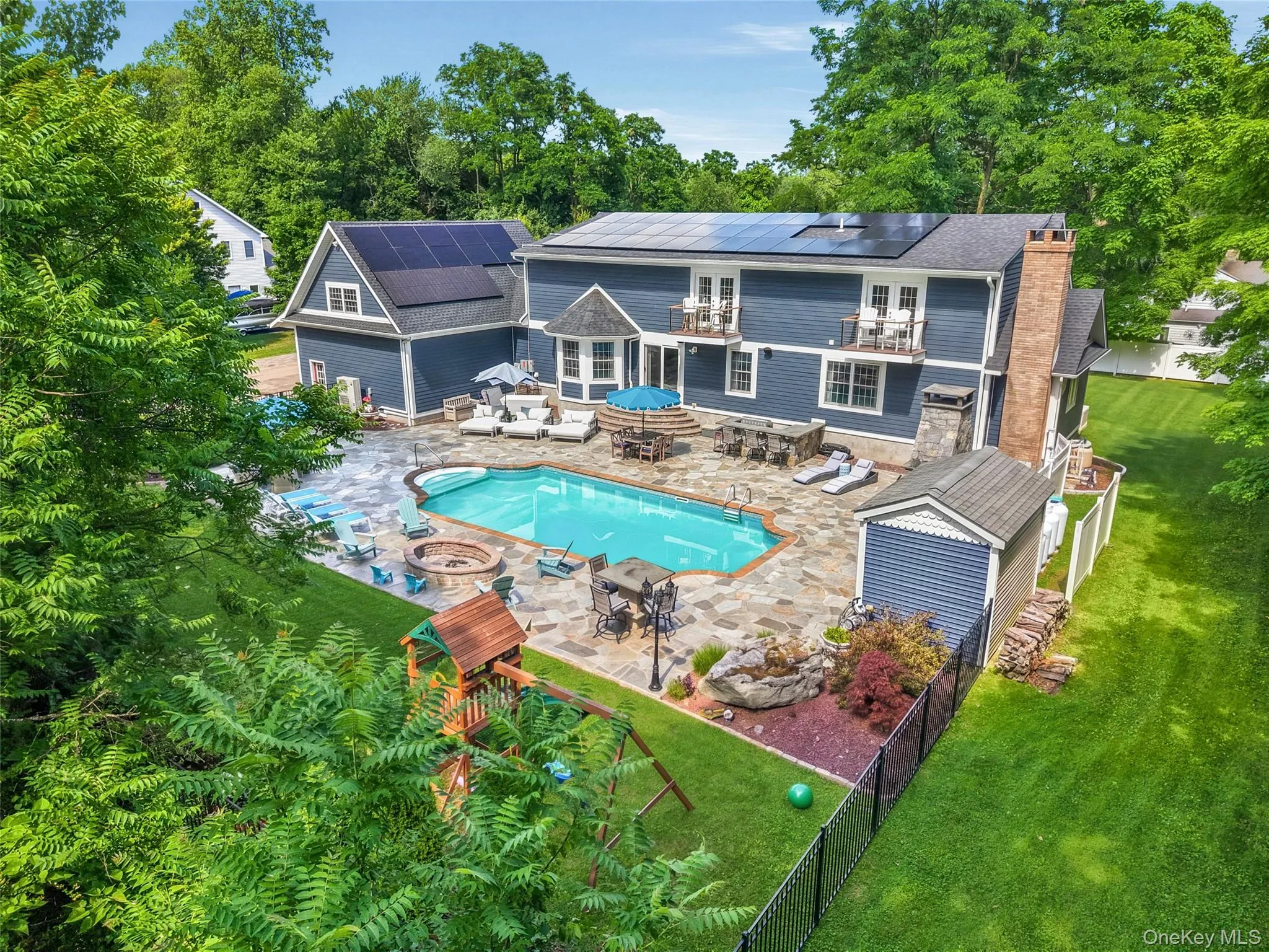 Expansive backyard oasis featuring a large inground swimming pool, flagstone patio, cold punge, built-in bbq, ice machine, playgrounds, fire pit, and mature trees Expansive backyard oasis featuring a large inground swimming pool, flagstone patio, cold punge, built-in bbq, ice machine, playgrounds, fire pit, and mature trees