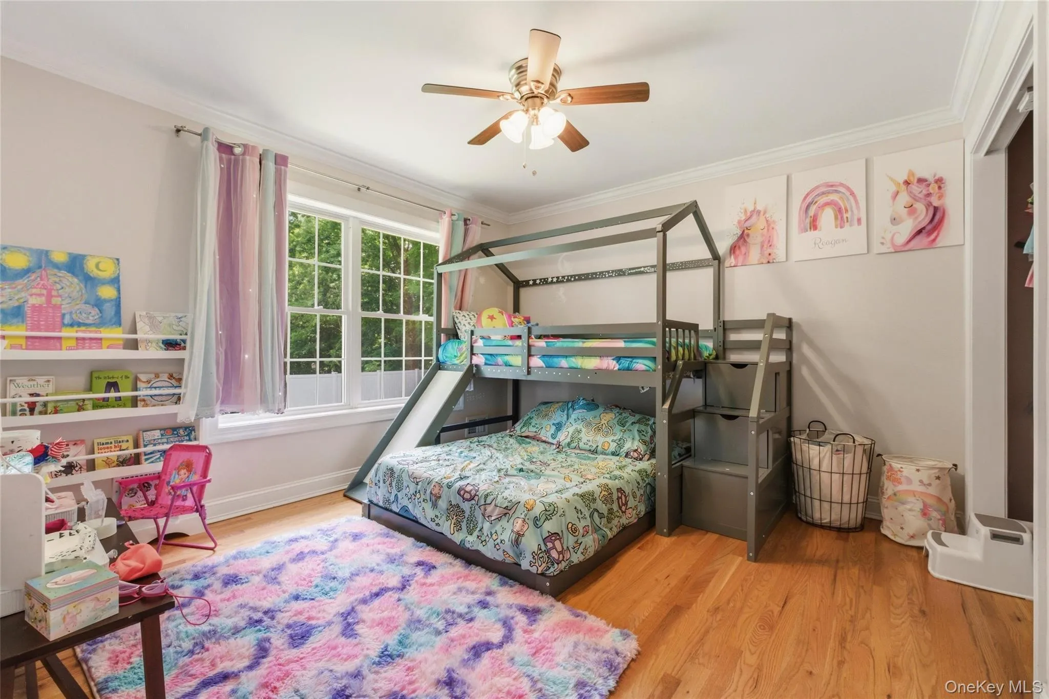 A bright and cheerful children’s bedroom designed with comfort and imagination in mind. A large window with soft curtains fills the space with natural light, while a reading nook, bookshelf, and fluffy rug create a cozy, functional environment for rest and play. A bright and cheerful children’s bedroom designed with comfort and imagination in mind. A large window with soft curtains fills the space with natural light, while a reading nook, bookshelf, and fluffy rug create a cozy, functional environment for rest and play.
