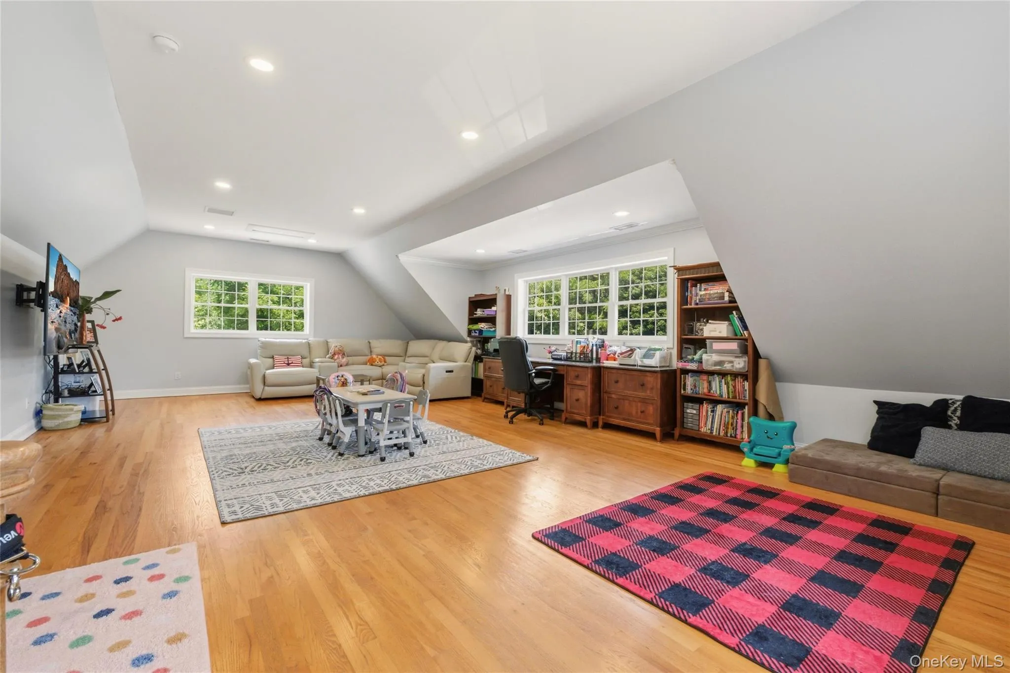 This expansive bonus room offers incredible versatility, perfect for a family lounge, playroom, or creative workspace. Featuring hardwood floors, and abundant natural light, the room includes a cozy sectional - it’s an ideal space for work, play, and relaxation all in one. This expansive bonus room offers incredible versatility, perfect for a family lounge, playroom, or creative workspace. Featuring hardwood floors, and abundant natural light, the room includes a cozy sectional - it’s an ideal space for work, play, and relaxation all in one.