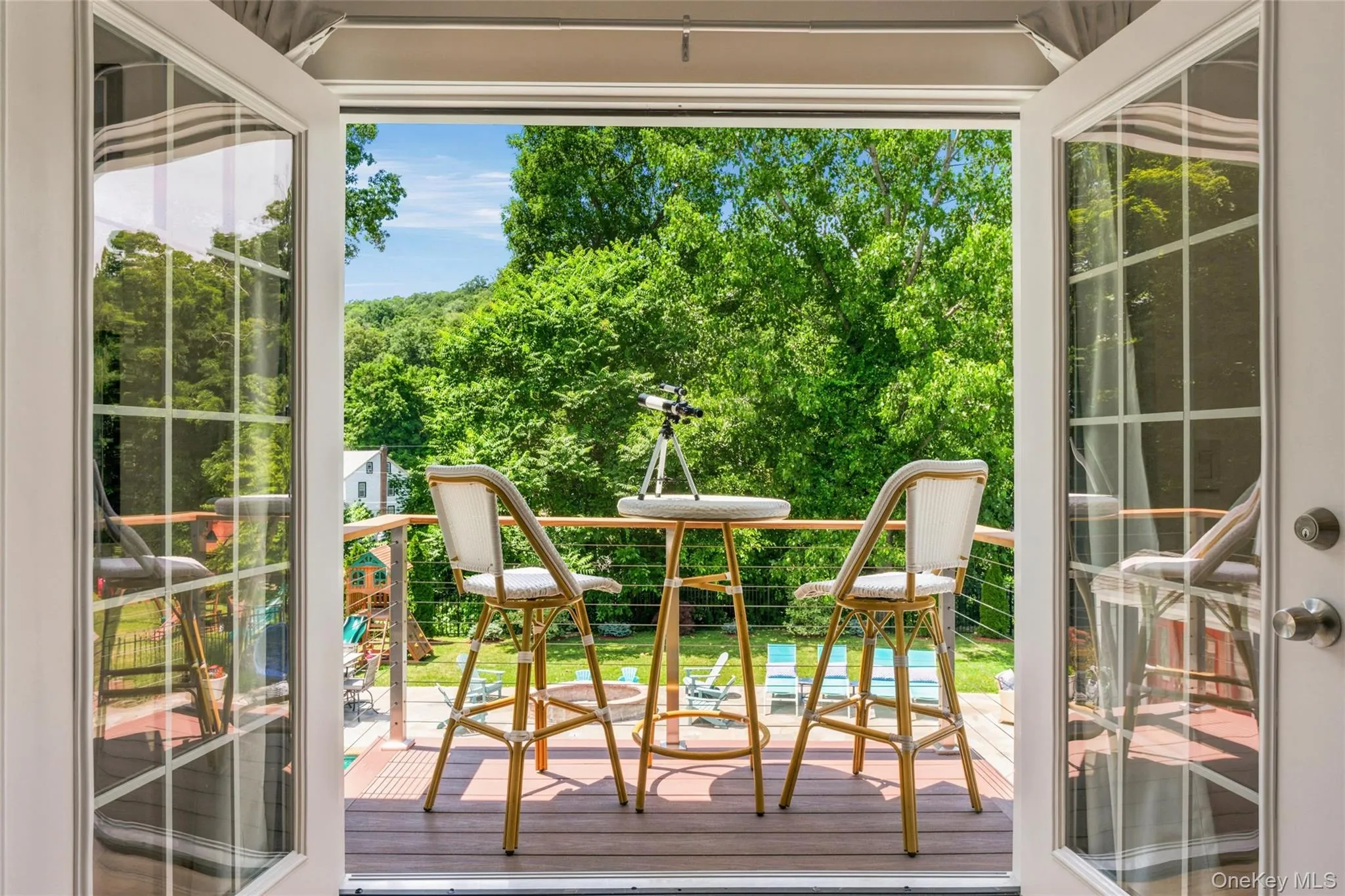 This serene balcony, right off the primary suite, offers a peaceful spot to relax, and views of the lush backyard. Perfect for morning coffee or evening stargazing. This serene balcony, right off the primary suite, offers a peaceful spot to relax, and views of the lush backyard. Perfect for morning coffee or evening stargazing.