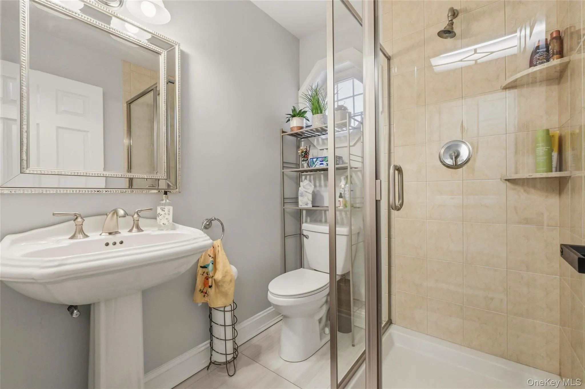 This modern bathroom features a clean and functional layout with a pedestal sink, framed mirror, and stylish lighting. The space feels fresh, bright, and well-maintained. This modern bathroom features a clean and functional layout with a pedestal sink, framed mirror, and stylish lighting. The space feels fresh, bright, and well-maintained.