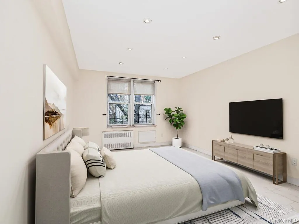 Bedroom featuring radiator and recessed lighting Bedroom featuring radiator and recessed lighting