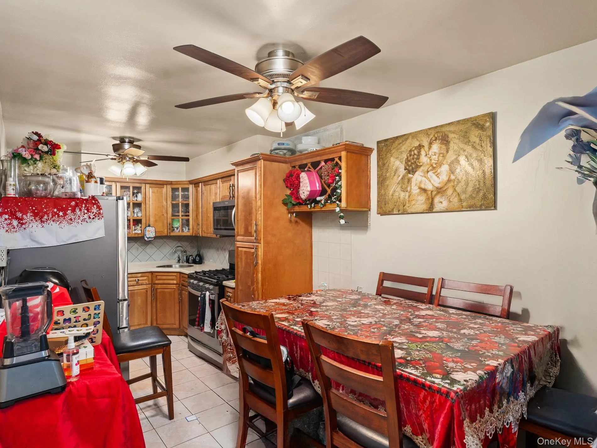1st. Floor Kitchen and dining area 1st. Floor featuring light wood cabinetry, stainless steel appliances, and a tiled backsplash 1st. Floor Kitchen and dining area 1st. Floor featuring light wood cabinetry, stainless steel appliances, and a tiled backsplash