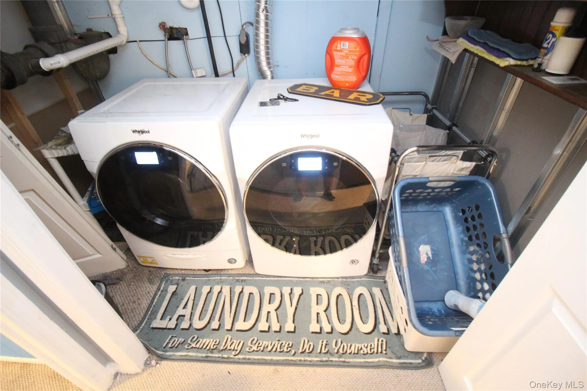 Dedicated laundry area in basement with front-loading washer and dryer units Dedicated laundry area in basement with front-loading washer and dryer units