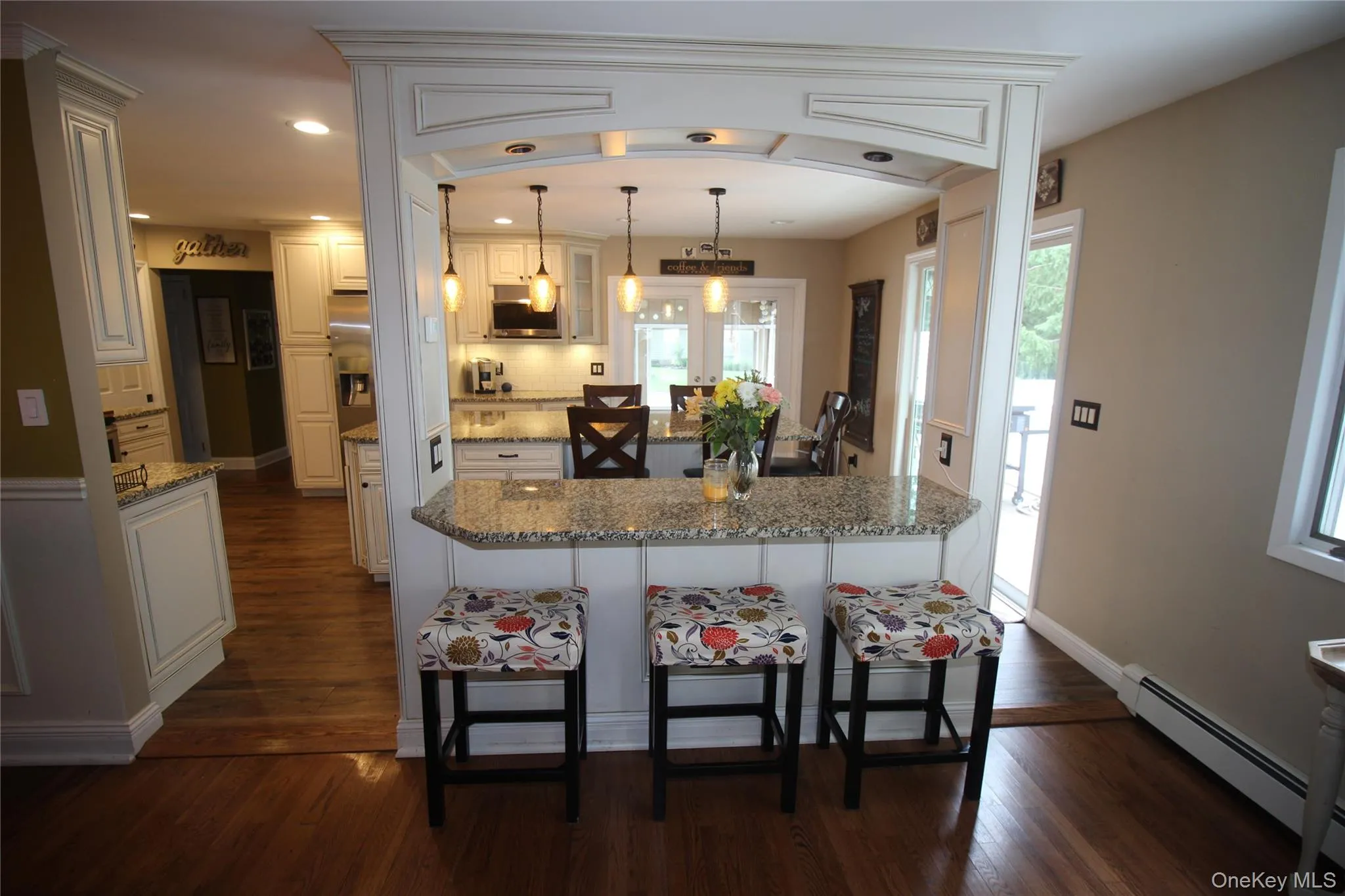 Divides Kitchen and Dining Room with Granite and decorative lighting Divides Kitchen and Dining Room with Granite and decorative lighting