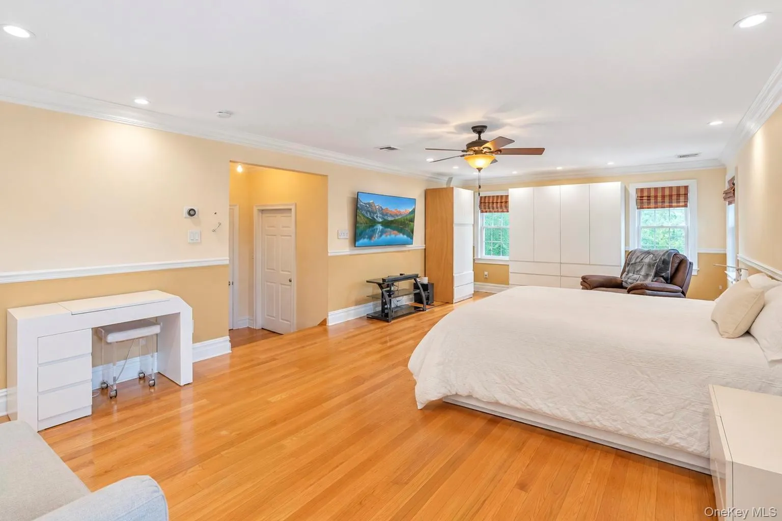 Wood-finish flooring throughout, with crown molding and recessed lighting Wood-finish flooring throughout, with crown molding and recessed lighting