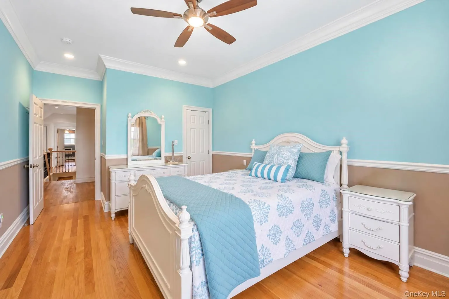 Hardwood flooring, crown molding, two-tone wall treatment, recessed lighting, and a ceiling fan with light Hardwood flooring, crown molding, two-tone wall treatment, recessed lighting, and a ceiling fan with light