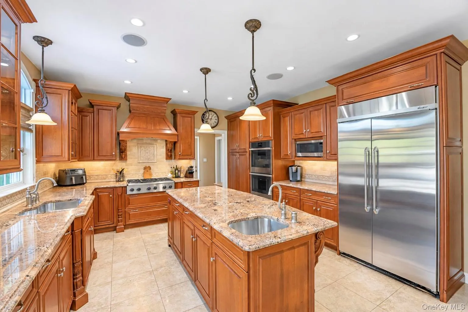Kitchen featuring wood cabinetry, light-toned countertop, stainless steel appliances, and recessed lighting Kitchen featuring wood cabinetry, light-toned countertop, stainless steel appliances, and recessed lighting