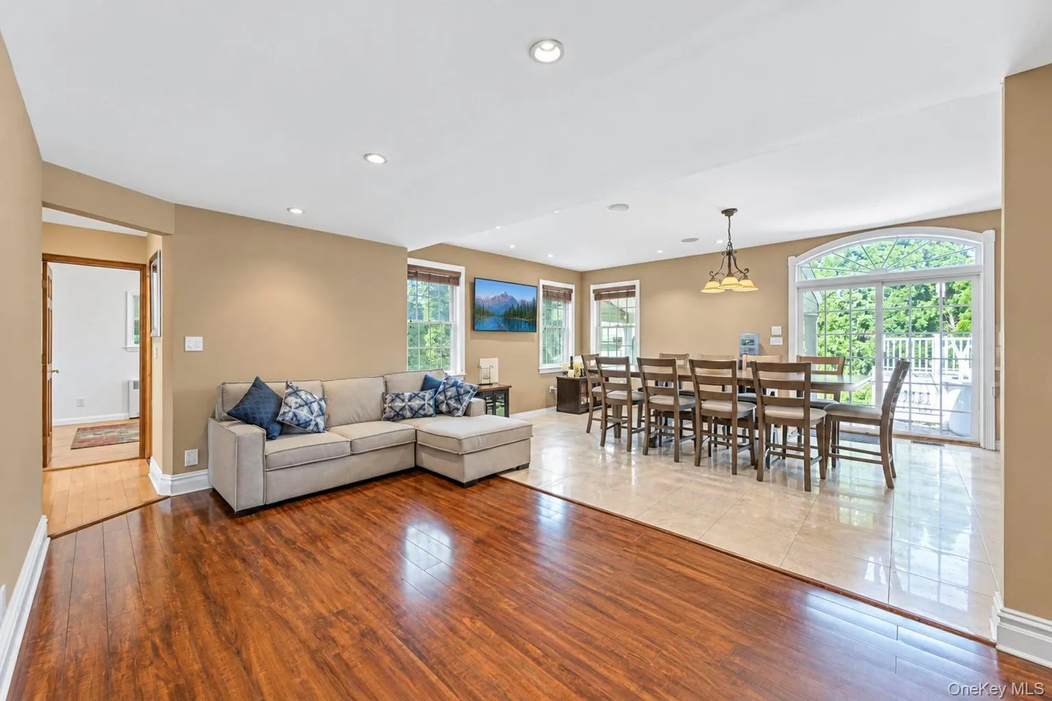 Hardwood flooring, recessed lighting, and a dining area with tile flooring Hardwood flooring, recessed lighting, and a dining area with tile flooring