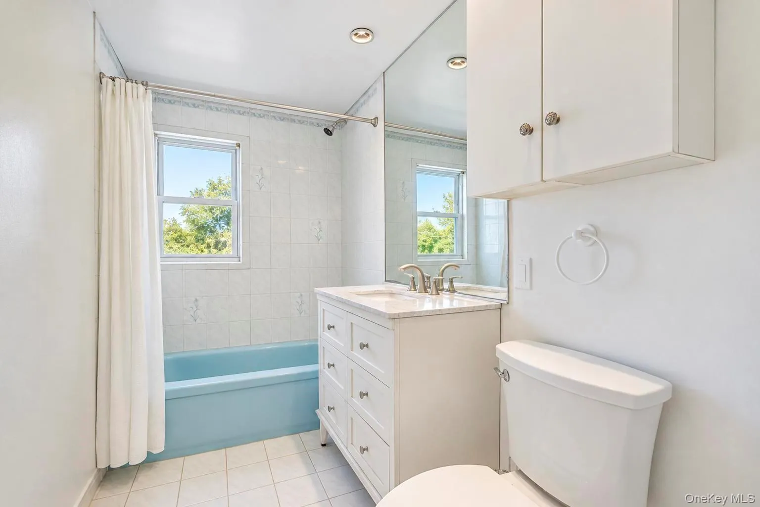 White vanity with ample drawer storage, integrated sink, and coordinating medicine cabinet White vanity with ample drawer storage, integrated sink, and coordinating medicine cabinet