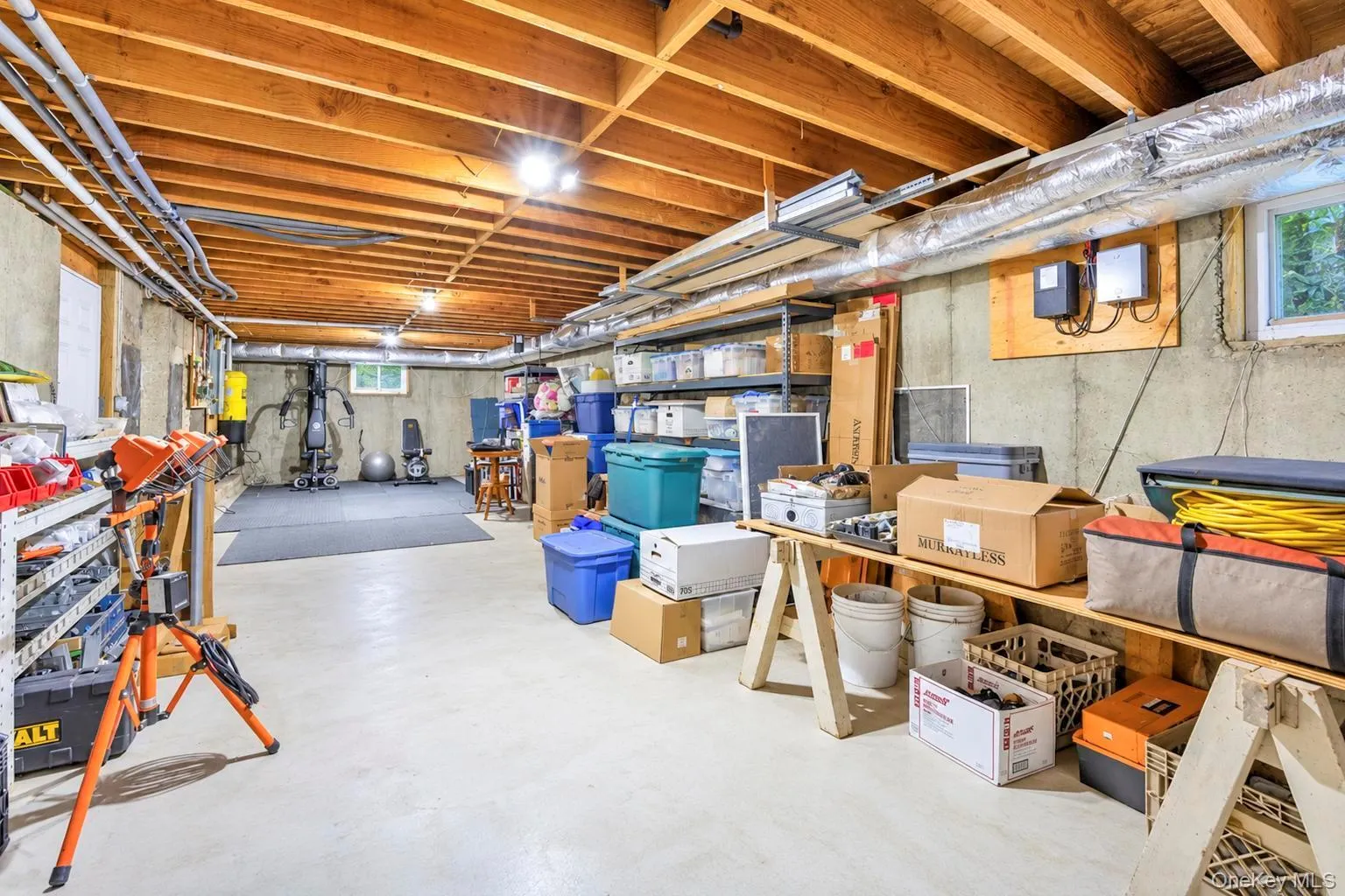 Great storage, exposed wood ceiling beams, concrete walls, painted concrete flooring, and an egress window Great storage, exposed wood ceiling beams, concrete walls, painted concrete flooring, and an egress window