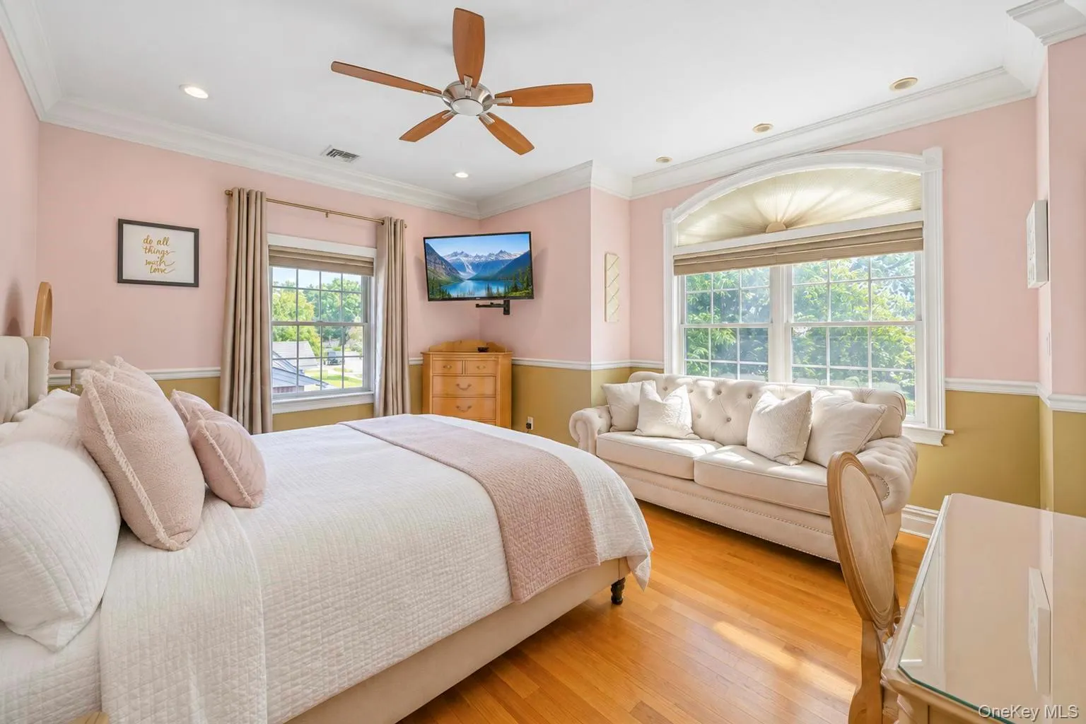 Hardwood flooring, recessed lighting, crown molding, ceiling fan, and large windows with arched detailing Hardwood flooring, recessed lighting, crown molding, ceiling fan, and large windows with arched detailing