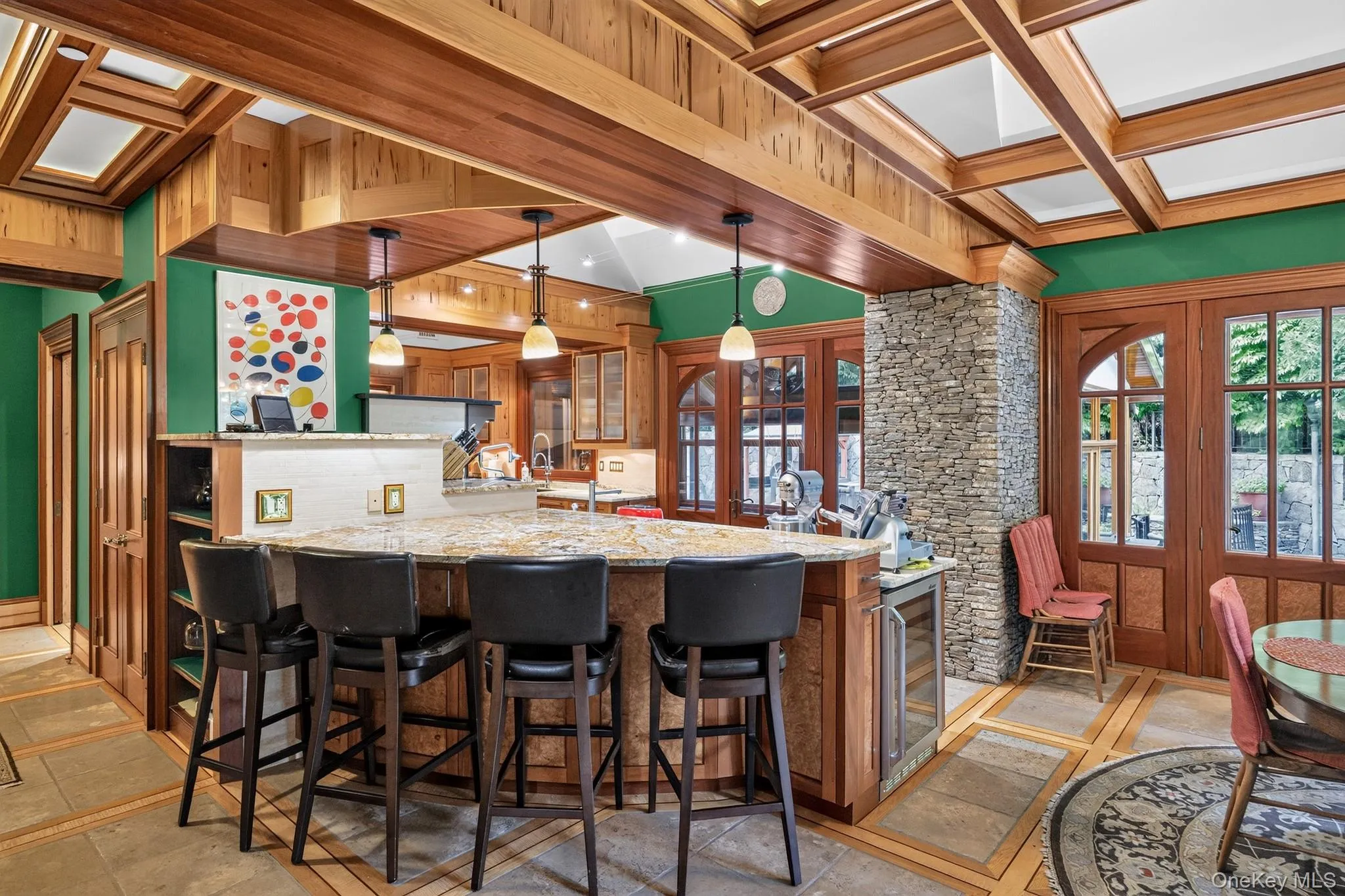 Kitchen island with granite countertop, integrated beverage cooler, and pendant lighting Kitchen island with granite countertop, integrated beverage cooler, and pendant lighting