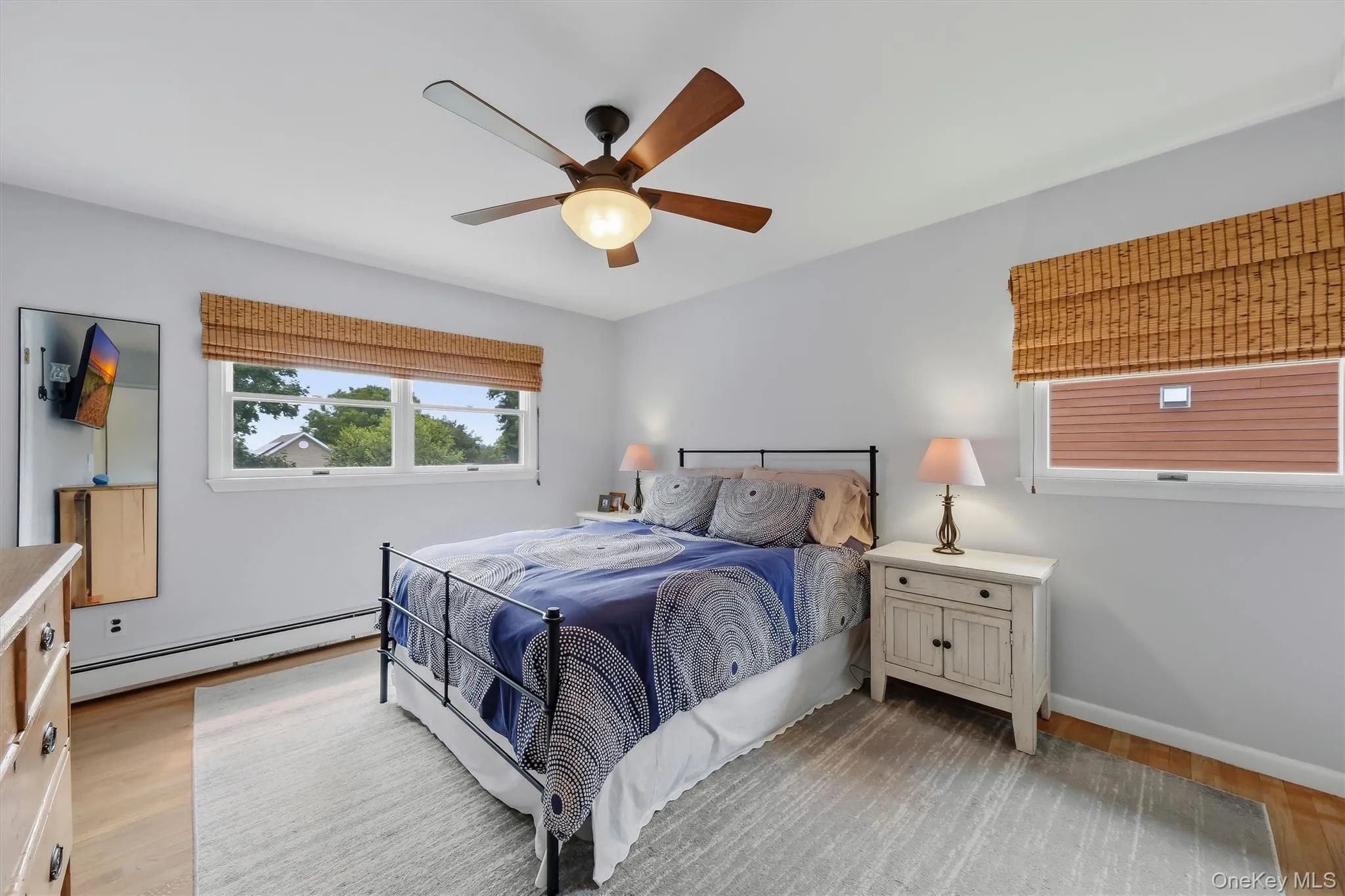 Primary bedroom with windows facing open, westward skies. Primary bedroom with windows facing open, westward skies.