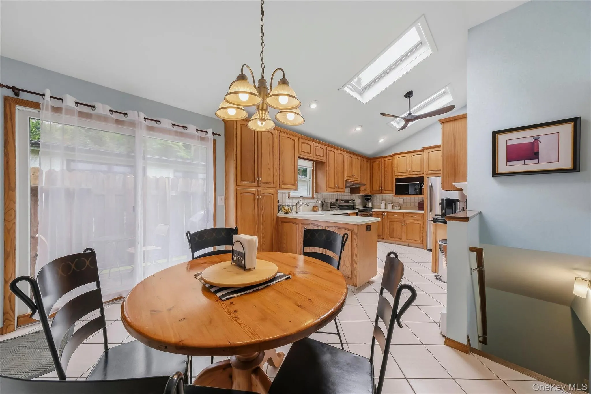 Skylights, soaring ceiling, and siding glass door provide an abundance of natural light. Skylights, soaring ceiling, and siding glass door provide an abundance of natural light.