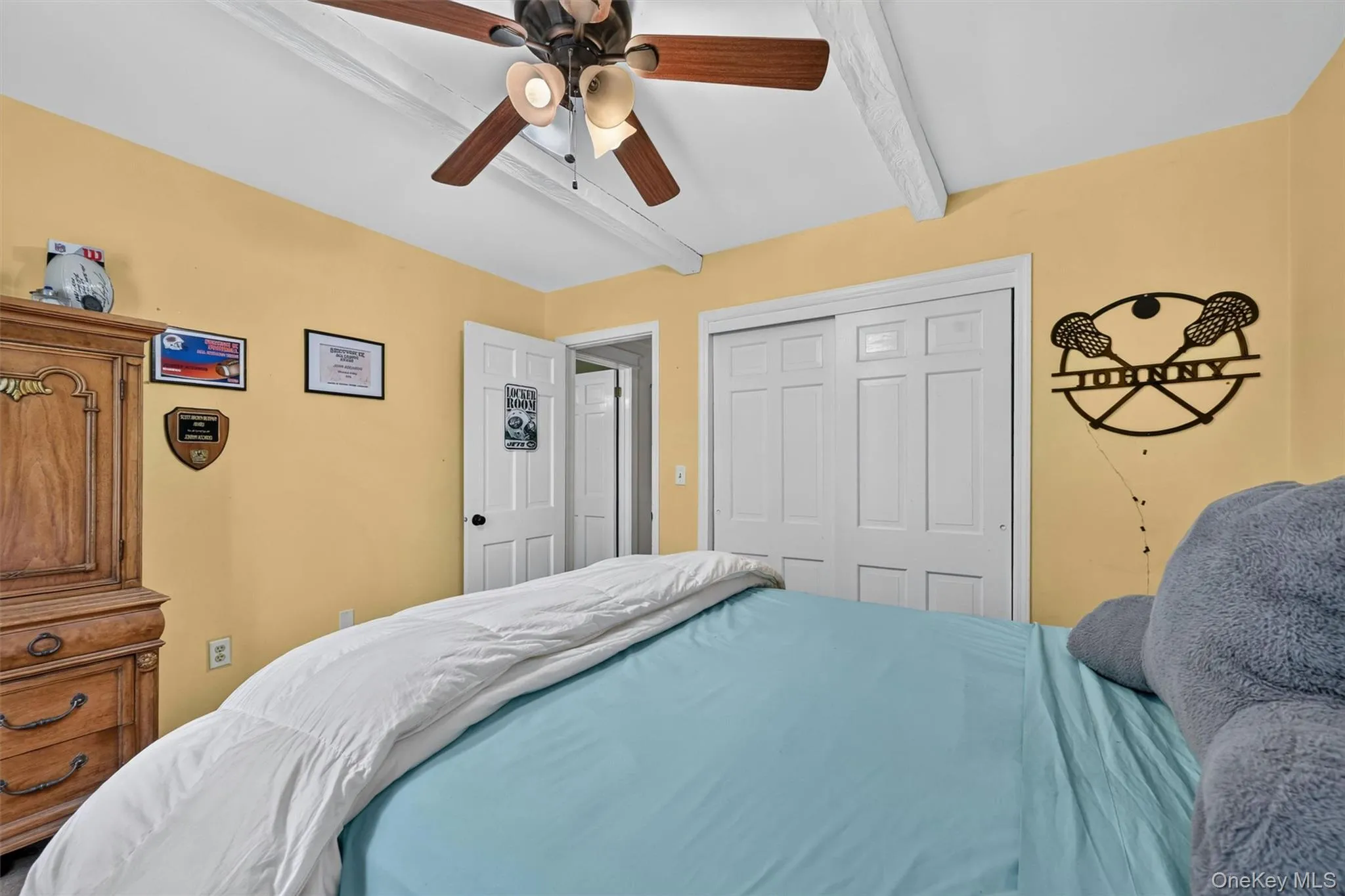 A bright secondary bedroom with a ceiling fan, closet storage, and enough space for a full bedroom setup. A bright secondary bedroom with a ceiling fan, closet storage, and enough space for a full bedroom setup.
