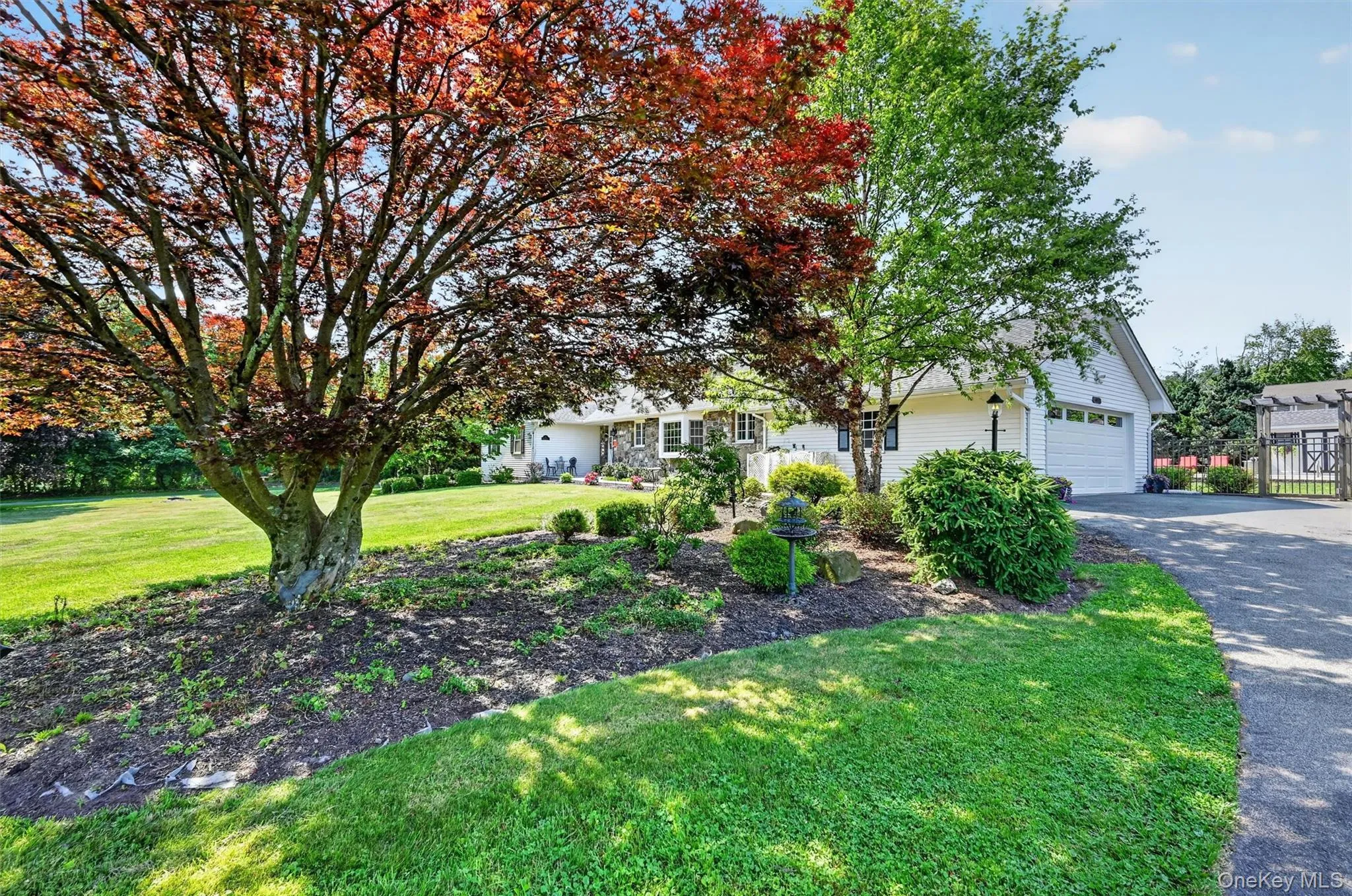 The propane-heated attached garage offers everyday convenience, while the mature landscaping and level front lawn add to the home’s welcoming curb appeal. The propane-heated attached garage offers everyday convenience, while the mature landscaping and level front lawn add to the home’s welcoming curb appeal.