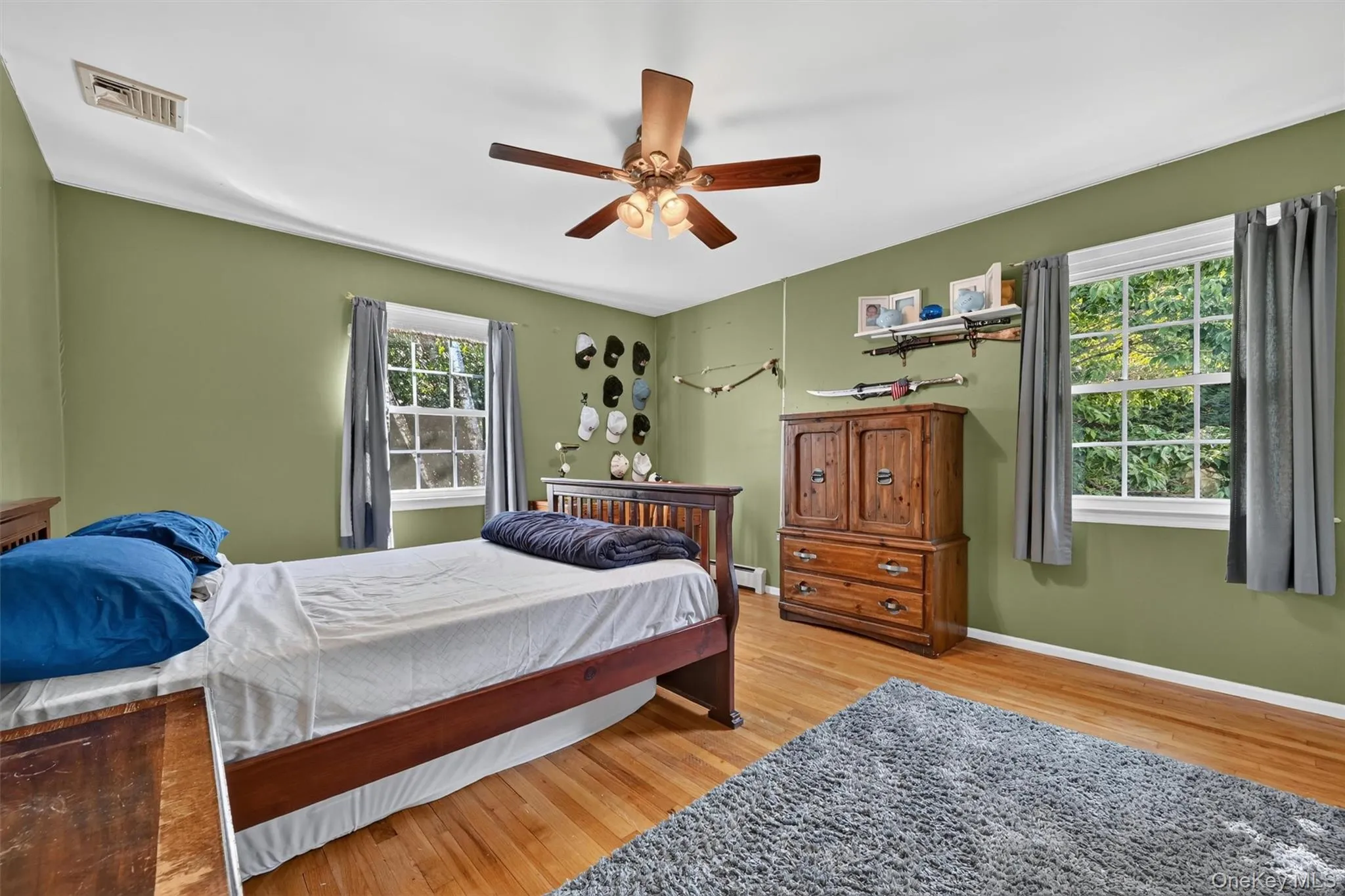 This spacious bedroom features hardwood floors, two windows, and a comfortable layout that can easily adapt to different needs. This spacious bedroom features hardwood floors, two windows, and a comfortable layout that can easily adapt to different needs.