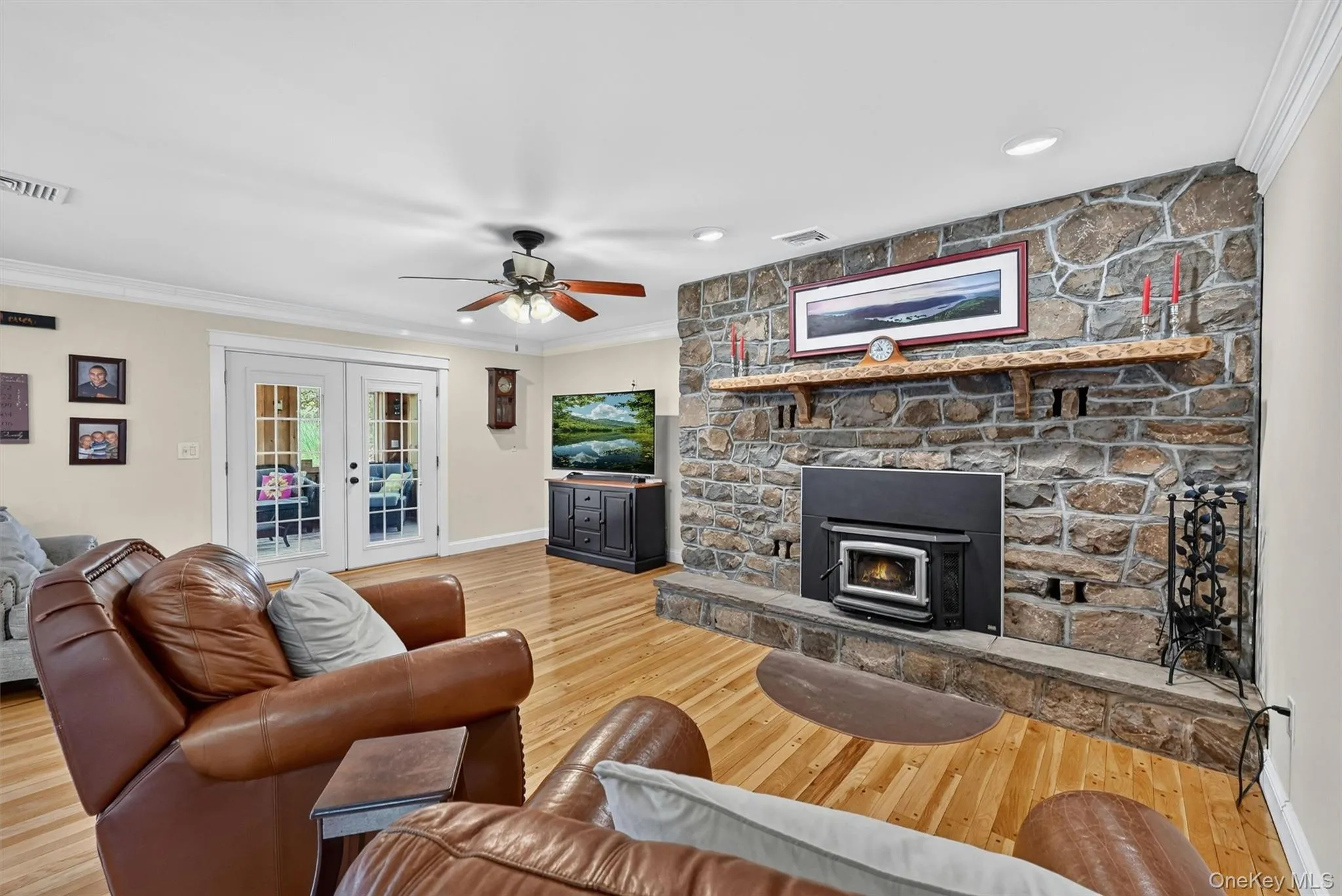 The spacious family room centers around a striking stone fireplace with a heat-efficient wood-burning insert, creating a warm and inviting place to gather. The spacious family room centers around a striking stone fireplace with a heat-efficient wood-burning insert, creating a warm and inviting place to gather.