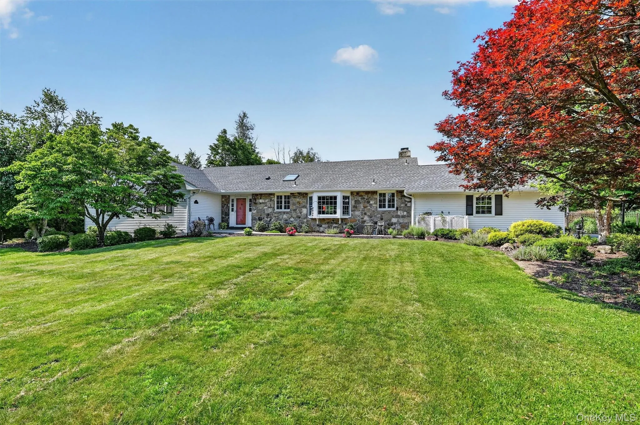 Classic stone and vinyl siding, mature landscaping, and a wide front lawn create a welcoming first impression at this 4 bedroom, 2.5 bath ranch in Warwick, NY. Classic stone and vinyl siding, mature landscaping, and a wide front lawn create a welcoming first impression at this 4 bedroom, 2.5 bath ranch in Warwick, NY.