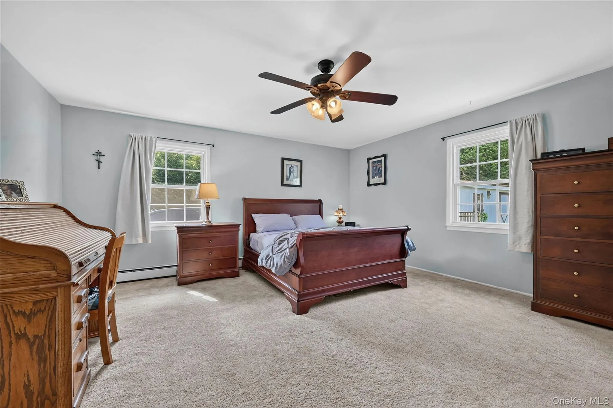 The spacious primary bedroom offers a calm, comfortable retreat with neutral finishes, soft natural light, and plenty of room for a full furniture arrangement. The spacious primary bedroom offers a calm, comfortable retreat with neutral finishes, soft natural light, and plenty of room for a full furniture arrangement.
