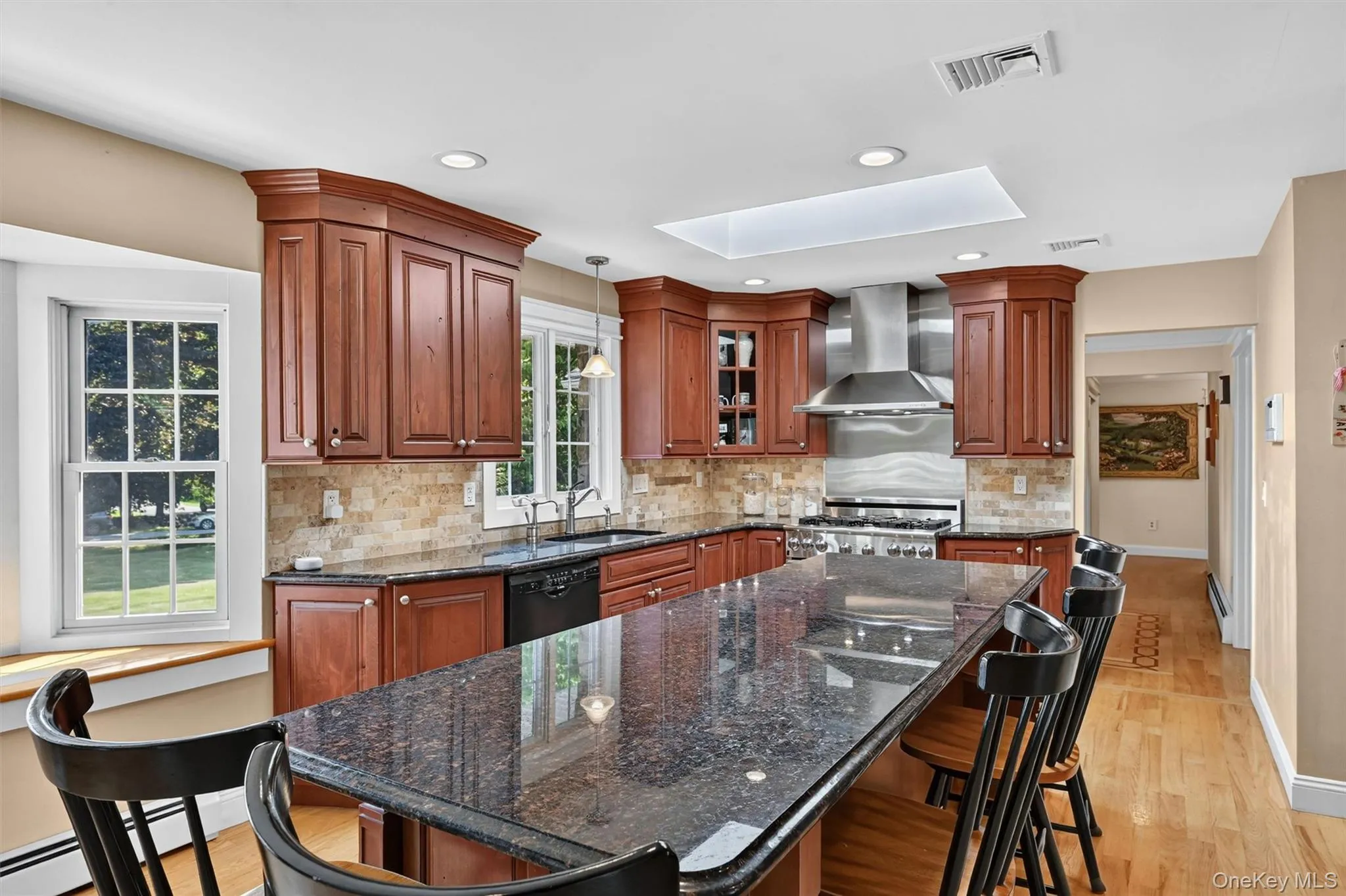 The large island/table combination creates the perfect place to prep, serve, or sit down to a casual meal in the heart of the home. The large island/table combination creates the perfect place to prep, serve, or sit down to a casual meal in the heart of the home.