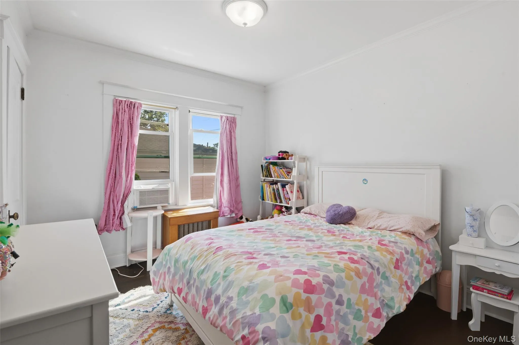 Bedroom with hardwood floors and oversized window Bedroom with hardwood floors and oversized window