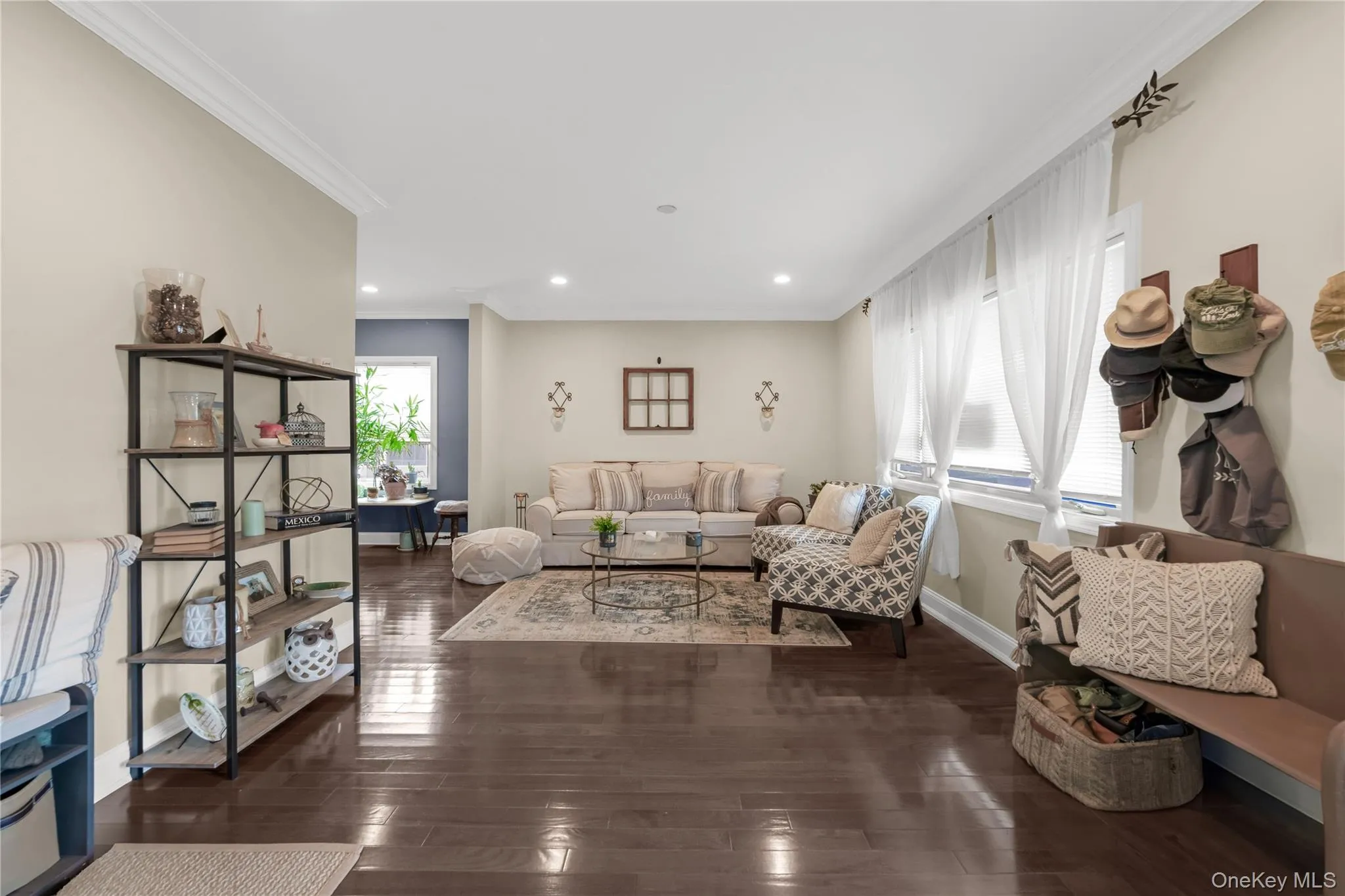 Open concept living area featuring dark wood-finish flooring, recessed lighting, and crown molding Open concept living area featuring dark wood-finish flooring, recessed lighting, and crown molding