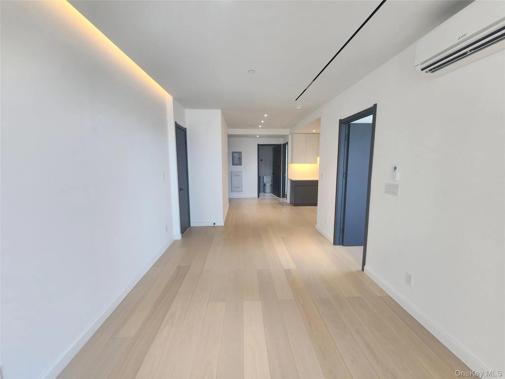 Light wood-finish flooring extending through an open living area Light wood-finish flooring extending through an open living area