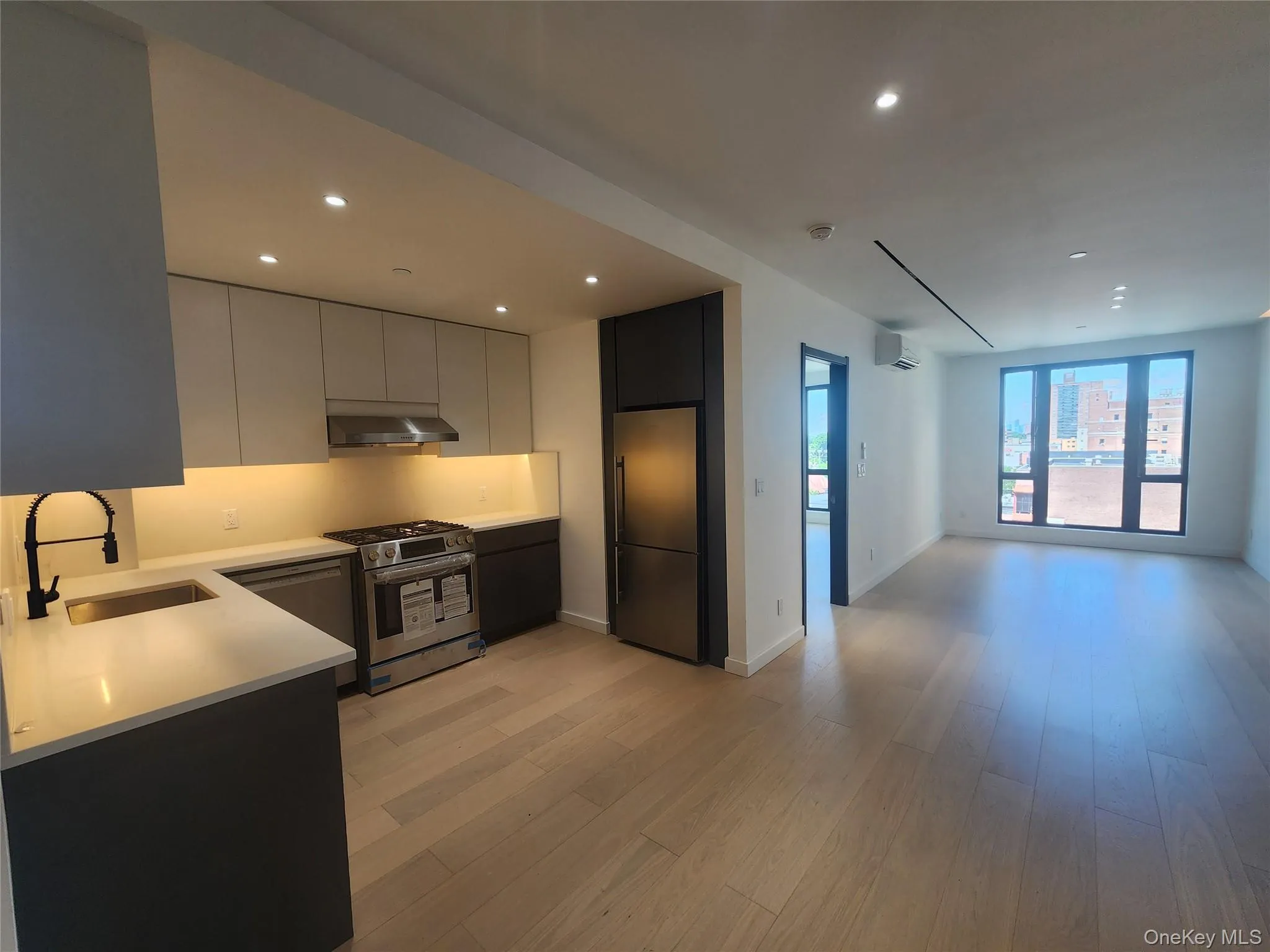 Modern kitchen featuring two-tone cabinetry, stainless steel appliances, and under-cabinet lighting Modern kitchen featuring two-tone cabinetry, stainless steel appliances, and under-cabinet lighting