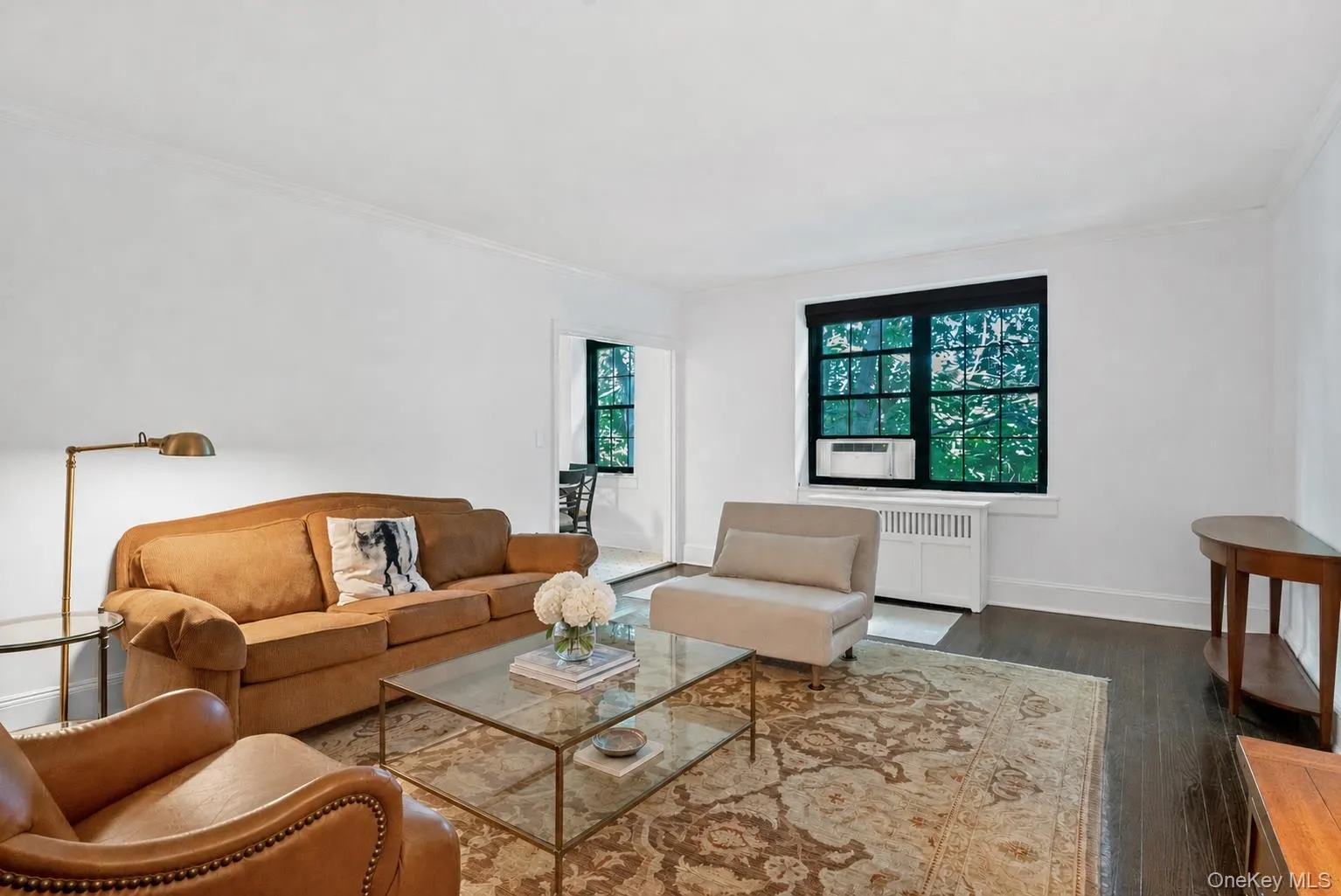 Sun-filled Living Room with Hardwood Floors and Treed Golf Views Sun-filled Living Room with Hardwood Floors and Treed Golf Views