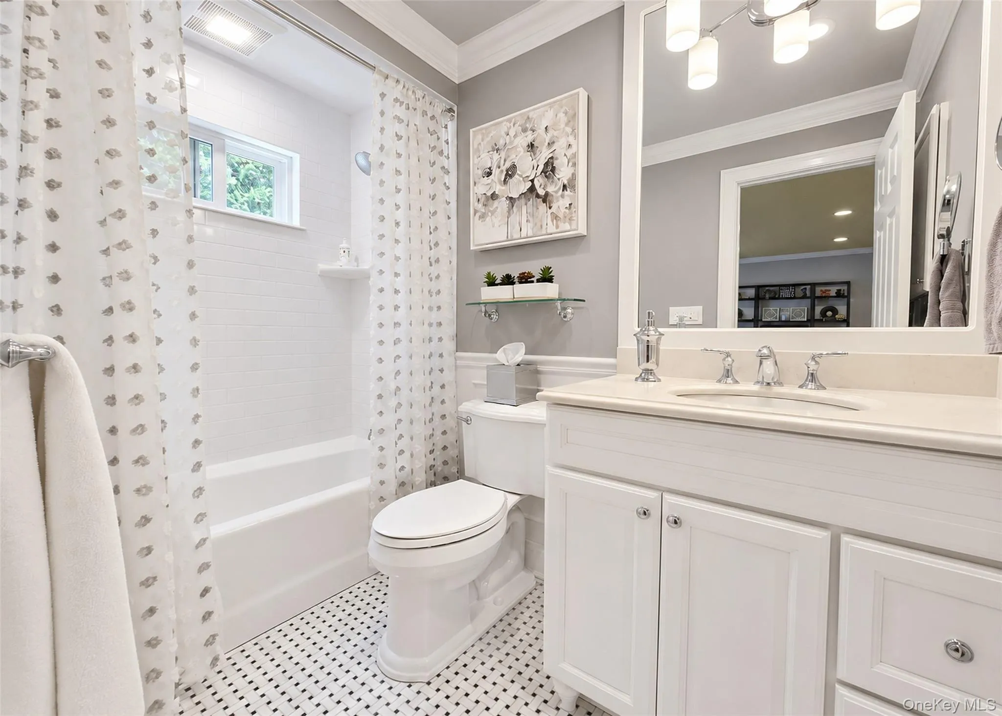 Bathroom featuring a white vanity with cabinet storage, a light-toned countertop, and a rectangular undermount sink Bathroom featuring a white vanity with cabinet storage, a light-toned countertop, and a rectangular undermount sink