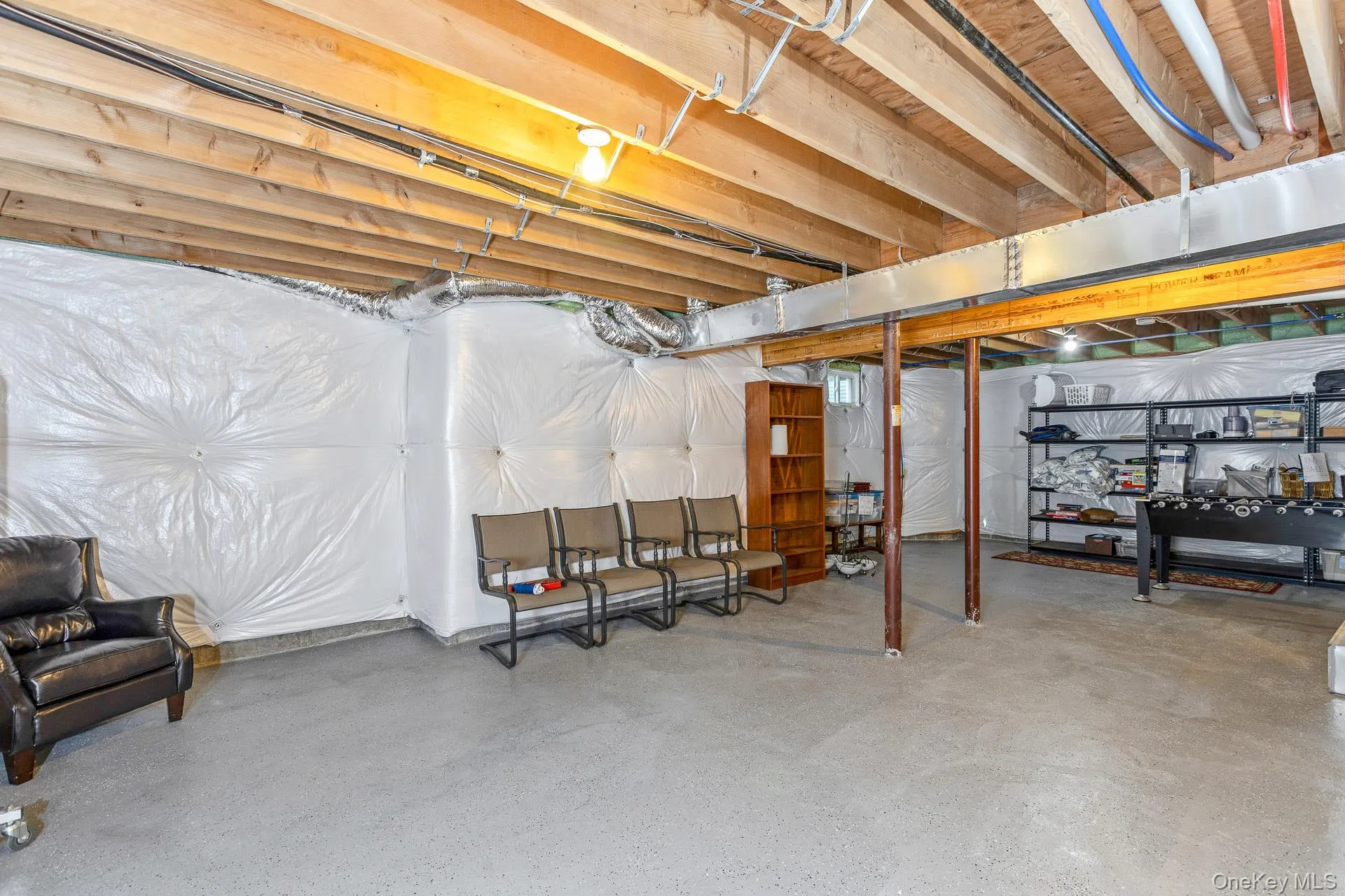 Unfinished basement featuring white wall insulation Unfinished basement featuring white wall insulation