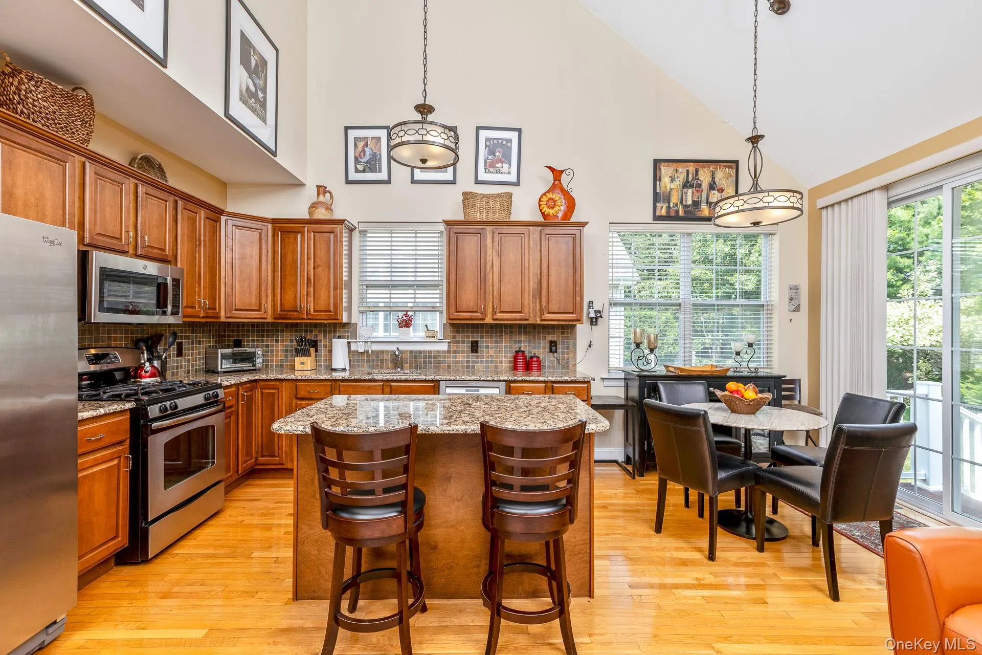Kitchen featuring wood-finish flooring and vaulted ceilings Kitchen featuring wood-finish flooring and vaulted ceilings