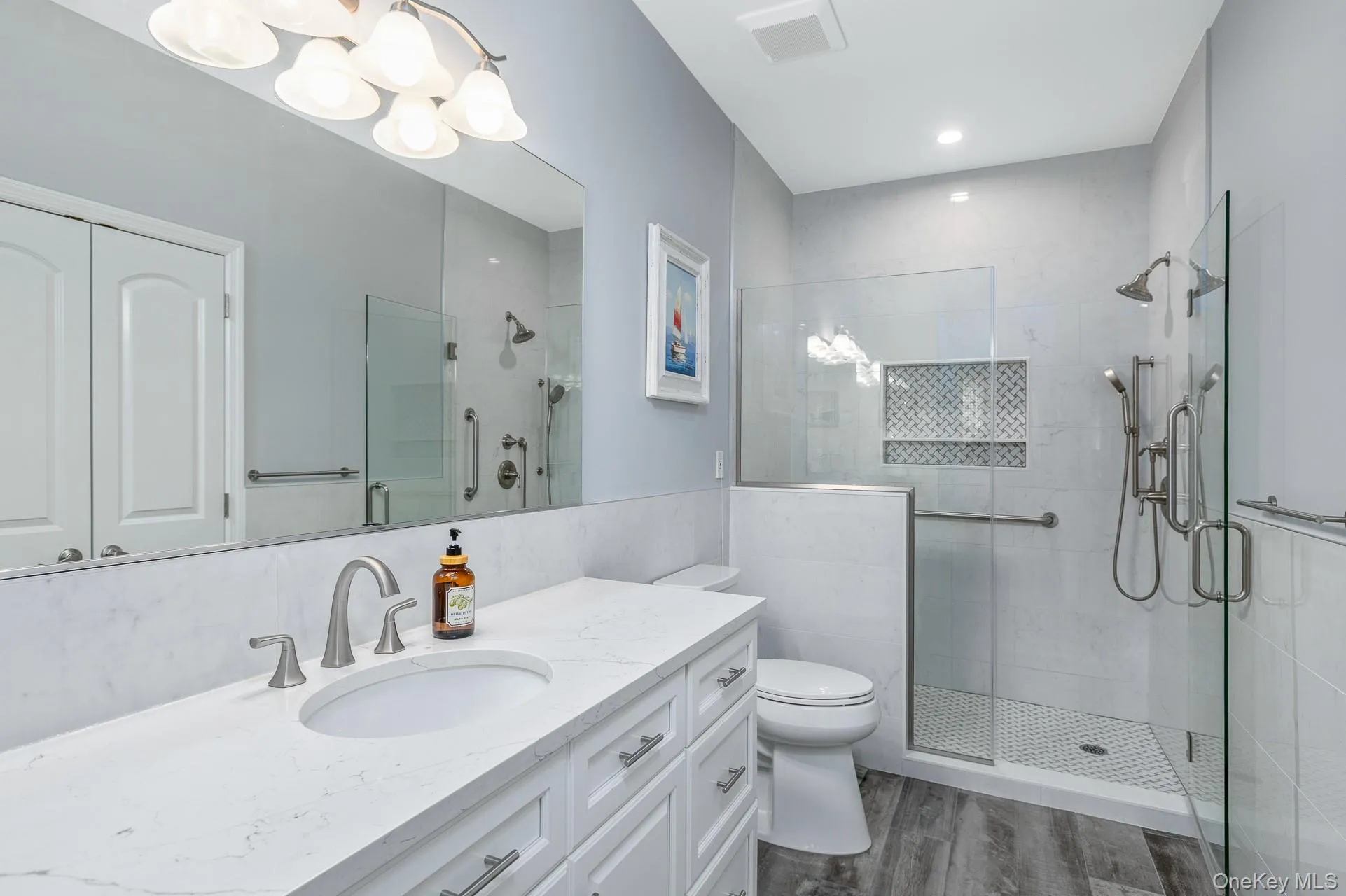 Primary Suite Bathroom featuring a glass-enclosed shower with multiple showerheads Primary Suite Bathroom featuring a glass-enclosed shower with multiple showerheads