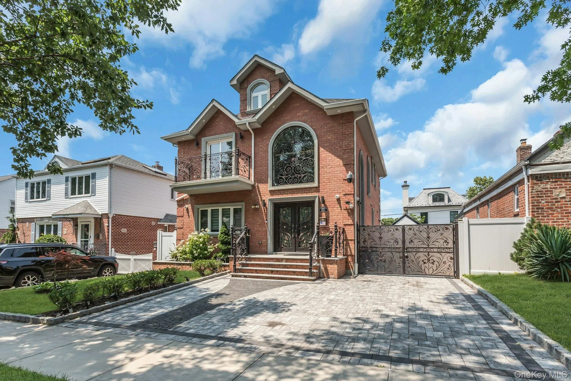 Featuring a full 2-car paver driveway, and professionally manicured landscaping wth inground sprinklers Featuring a full 2-car paver driveway, and professionally manicured landscaping wth inground sprinklers