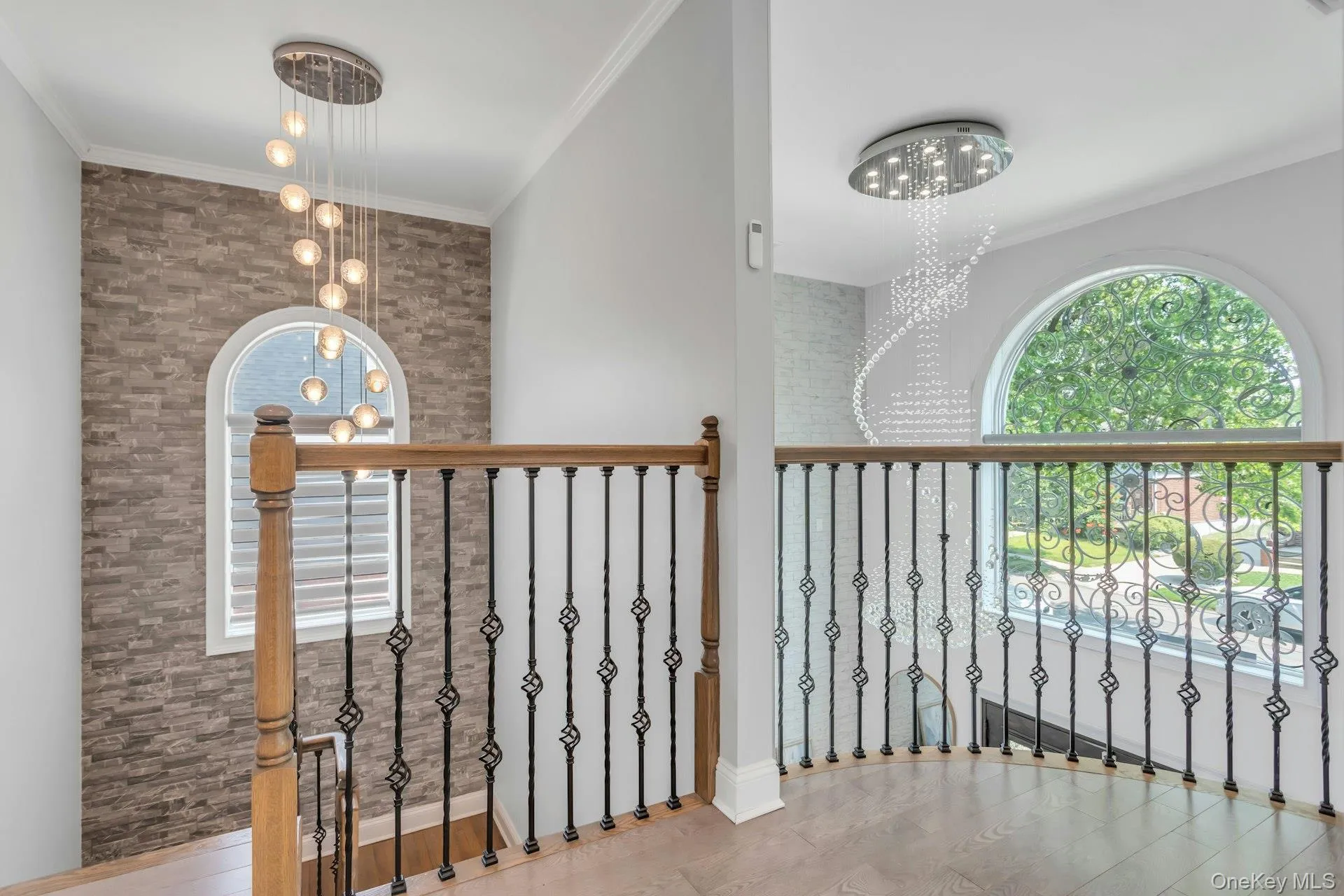 2nd story entry view, Stacked stone accent wall,Custom wood and decorative iron railing, glass chandelier, front pictureseque elliptical window adding grand focal point, for great curb appeal 2nd story entry view, Stacked stone accent wall,Custom wood and decorative iron railing, glass chandelier, front pictureseque elliptical window adding grand focal point, for great curb appeal