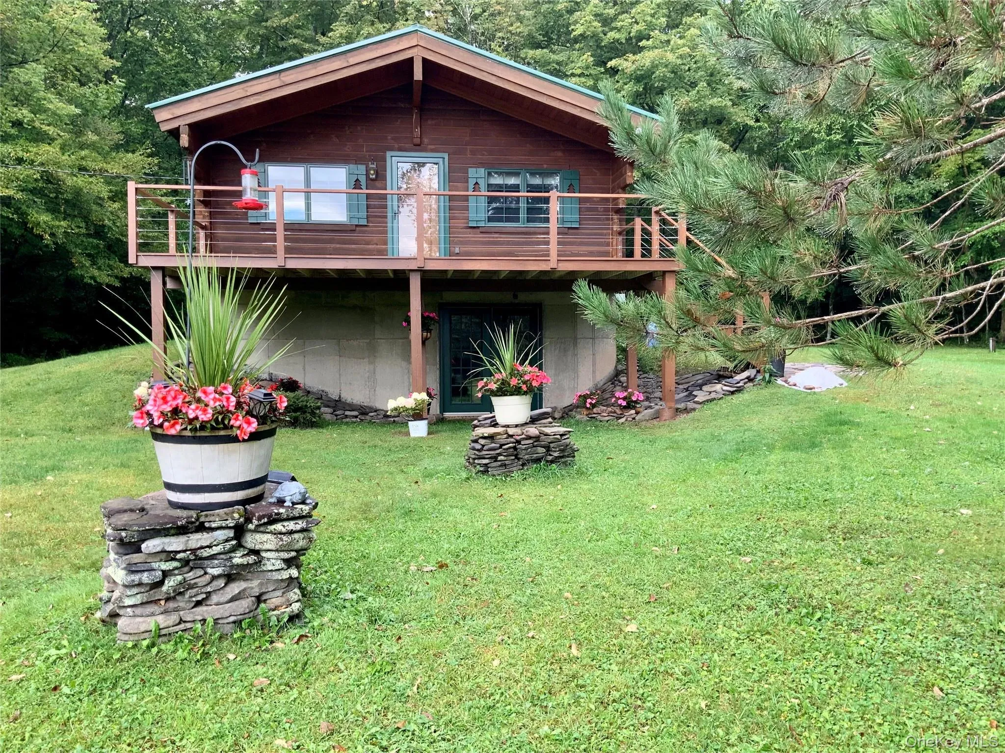THis picturesque log cabin is set against a lush green landscape offering privacy and a peaceful retreat. THis picturesque log cabin is set against a lush green landscape offering privacy and a peaceful retreat.