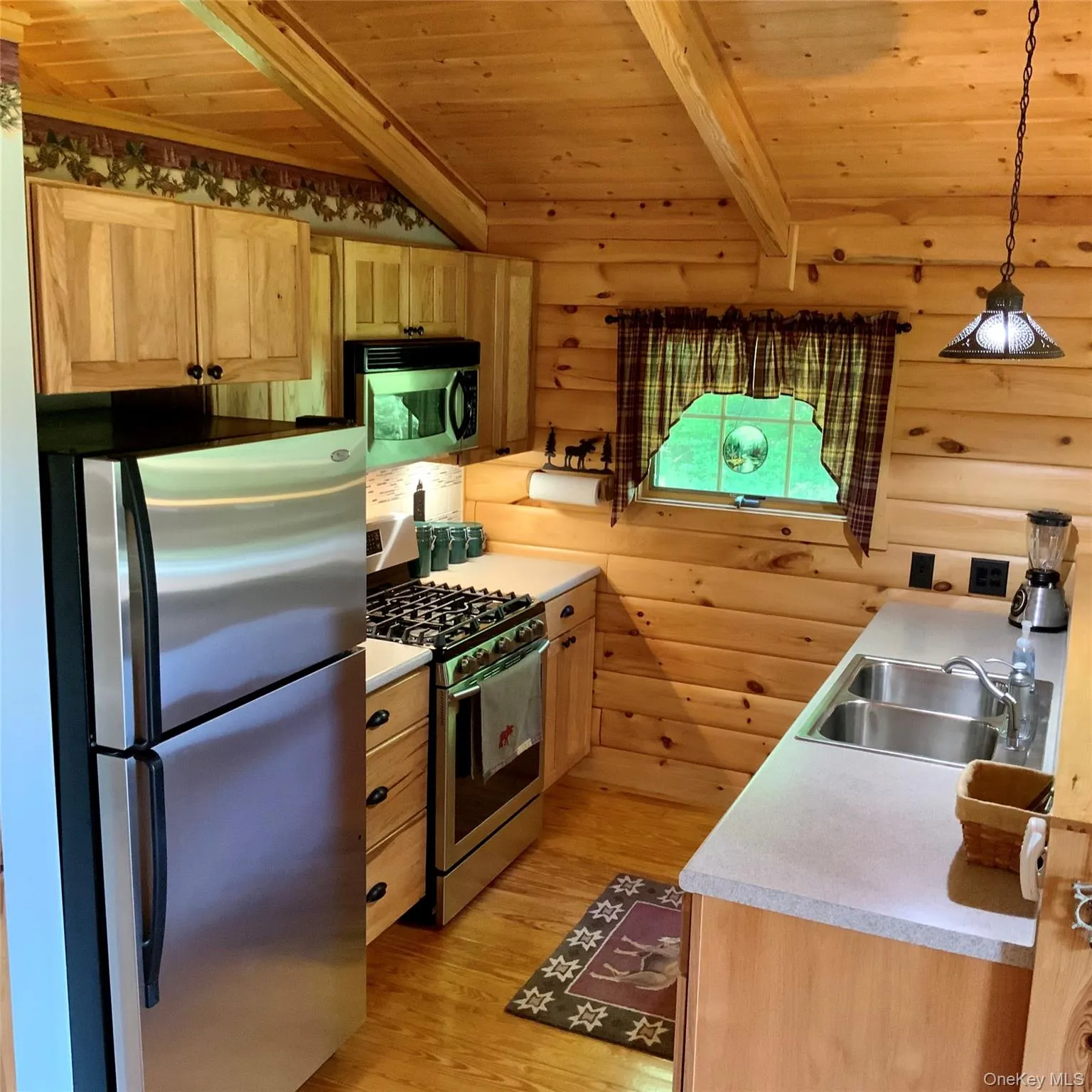 The functional kitchen offers generous workspace and beautiful woodland views. The functional kitchen offers generous workspace and beautiful woodland views.