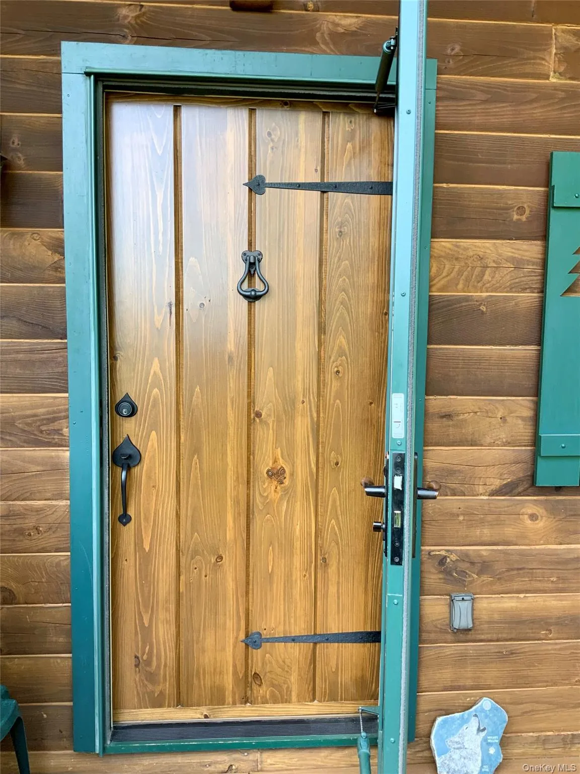 Rustic handcrafted custom “Adirondack Naturals” front door welcomes you with timeless log home character. Rustic handcrafted custom “Adirondack Naturals” front door welcomes you with timeless log home character.
