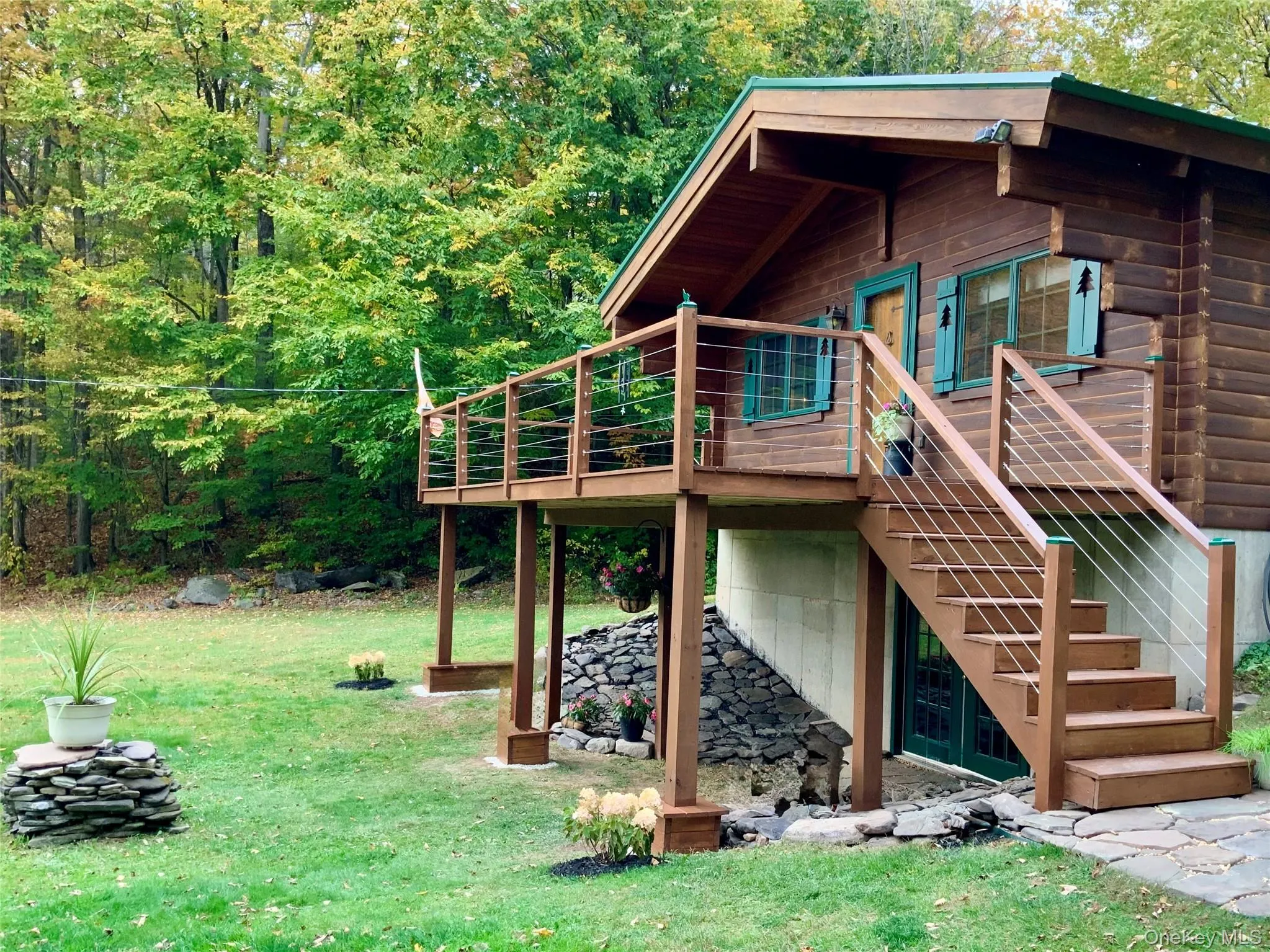 Elevated front deck overlooking the expansive lawn and woodland backdrop. Elevated front deck overlooking the expansive lawn and woodland backdrop.