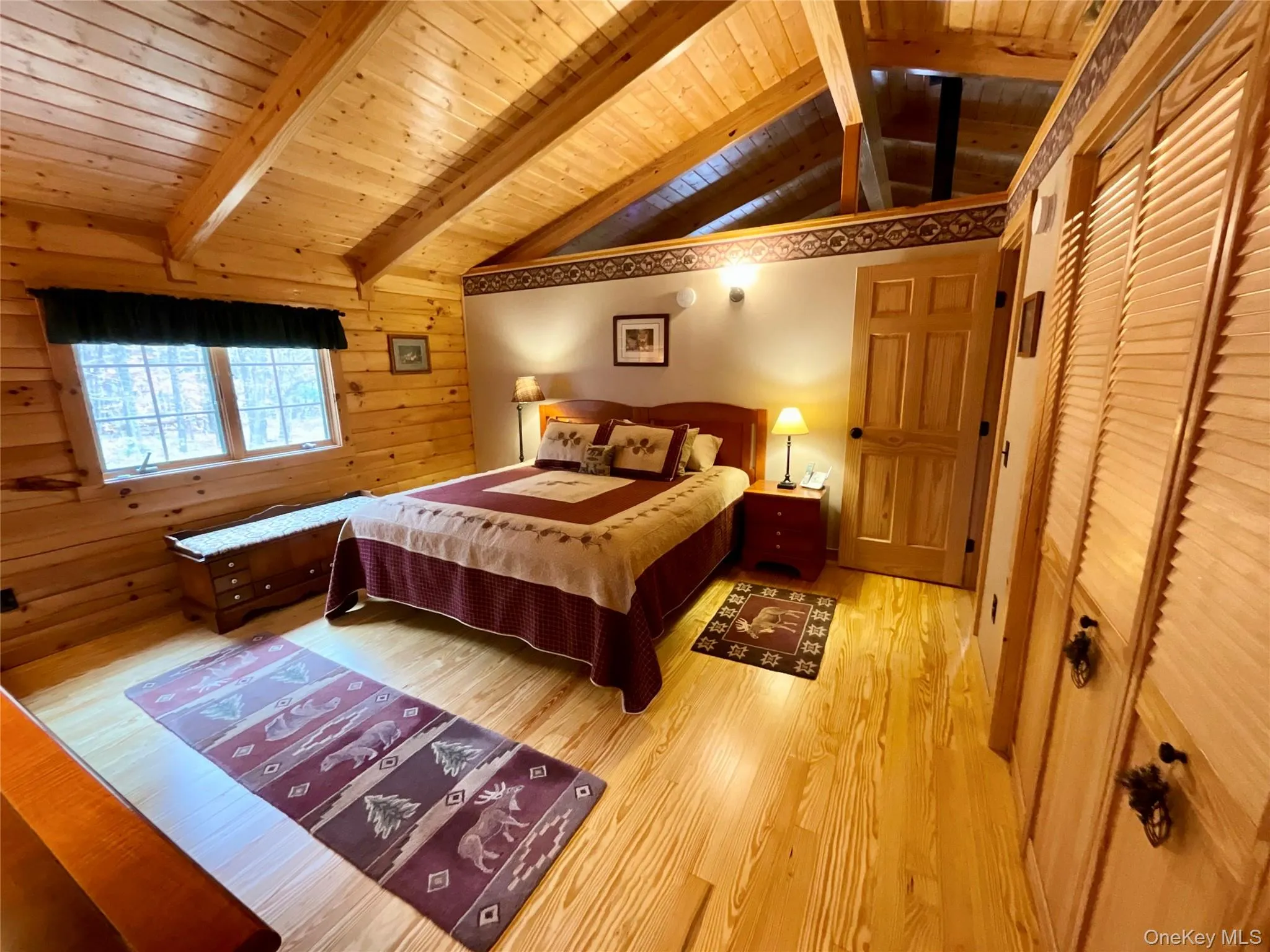 The bedroom features vaulted ceilings, warm wood accents and peaceful views. The bedroom features vaulted ceilings, warm wood accents and peaceful views.