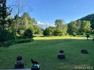 A generous open lawn provides plenty of room to relax, play, or enjoy the privacy and natural beauty of the surrounding landscape. A generous open lawn provides plenty of room to relax, play, or enjoy the privacy and natural beauty of the surrounding landscape.