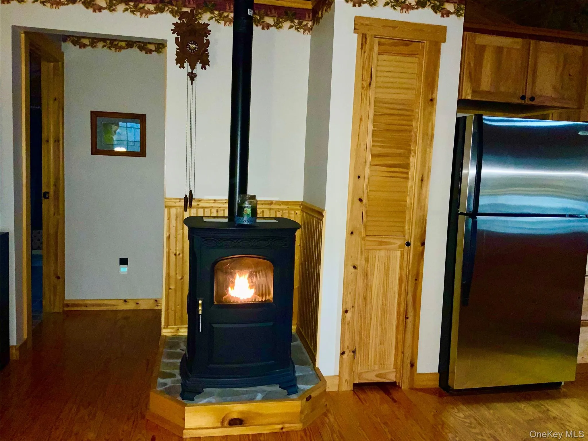 The cozy pellet stove adds warmth and charm to the home's open living space. The cozy pellet stove adds warmth and charm to the home's open living space.