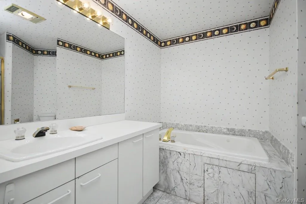Primary Bathroom has sink with vanity and bathtub with jacuzzi Primary Bathroom has sink with vanity and bathtub with jacuzzi