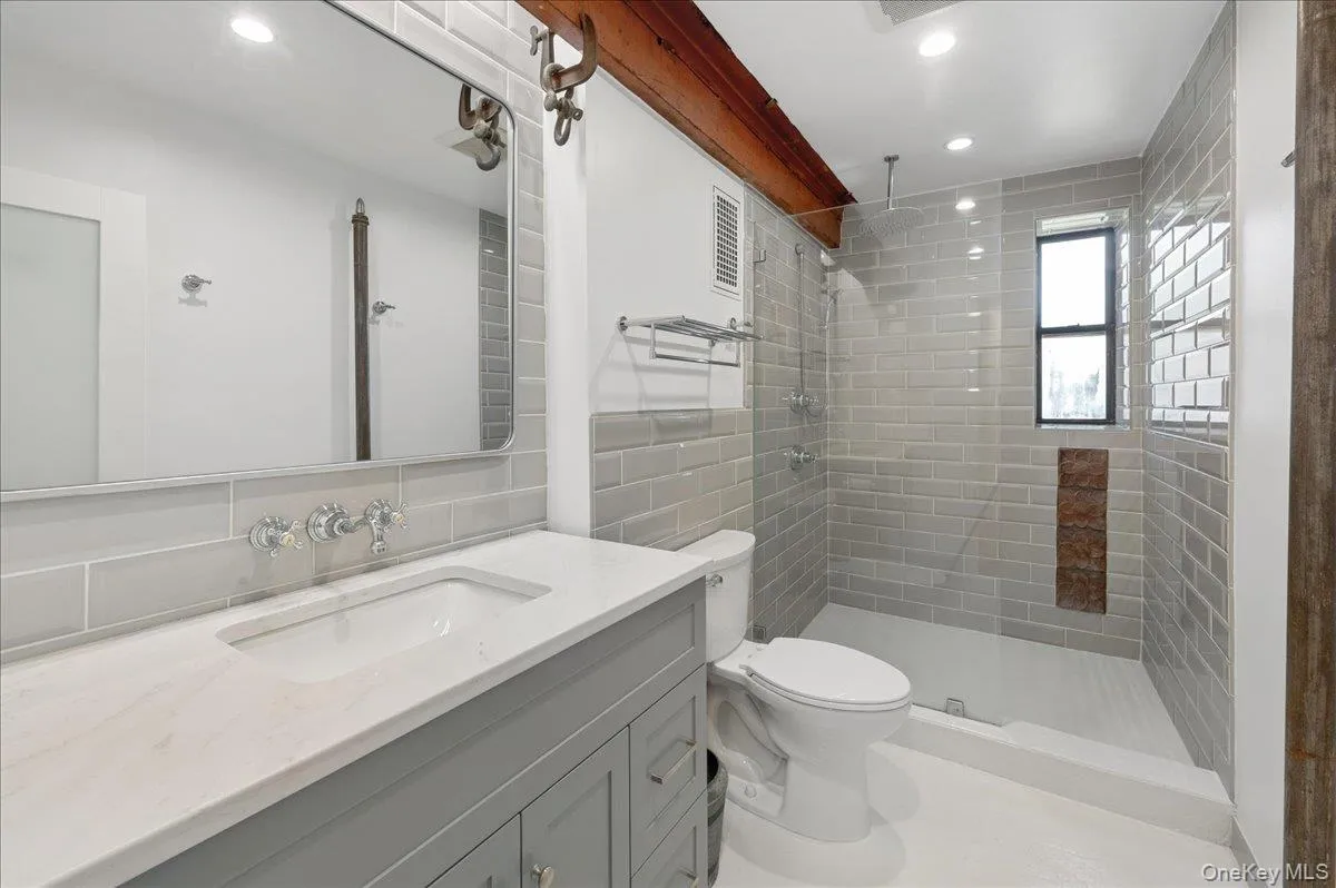 Stunning primary bathroom features original beam Stunning primary bathroom features original beam