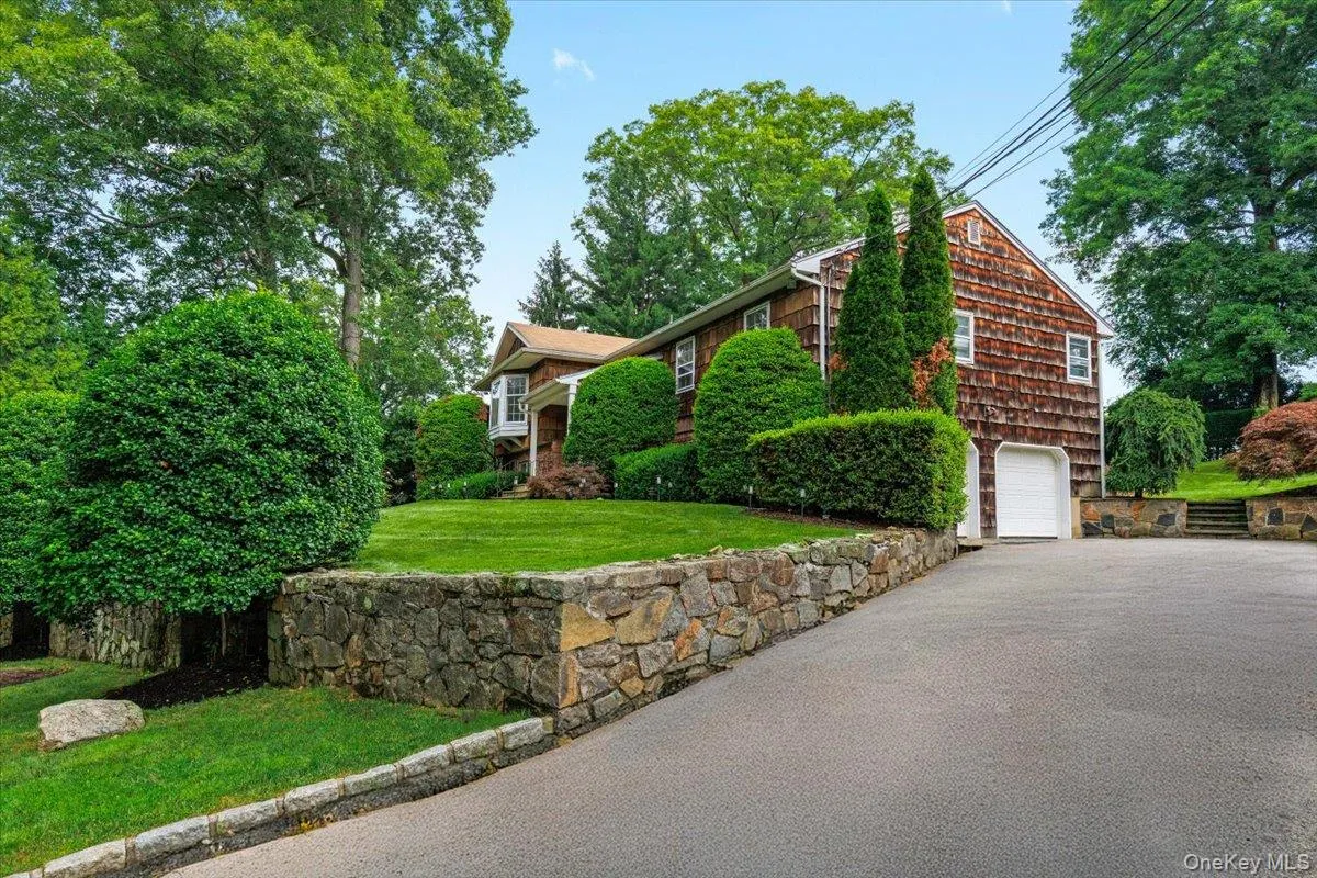 Nice approach with stone walls to two car garage. Gracious driveway allows for ample guest parking. Nice approach with stone walls to two car garage. Gracious driveway allows for ample guest parking.